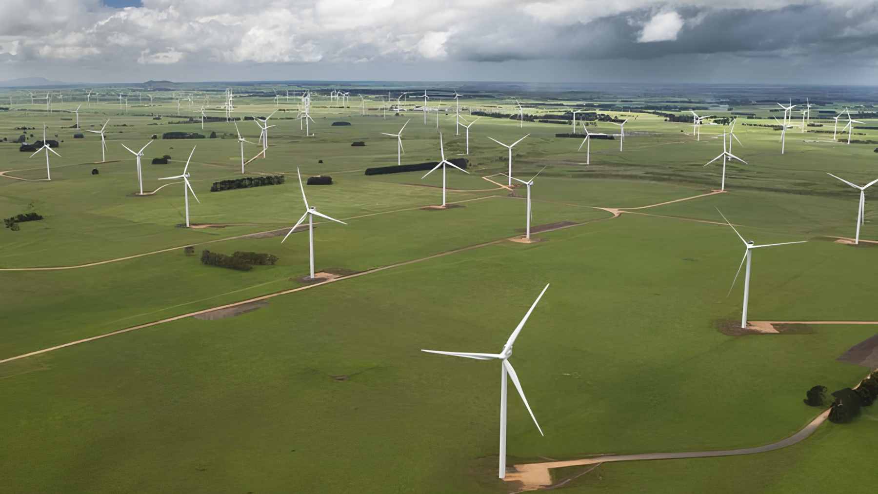 A wind turbine operating in a rural landscape, representing how renewable energy projects are integrating wildlife protection into their engineering designs.