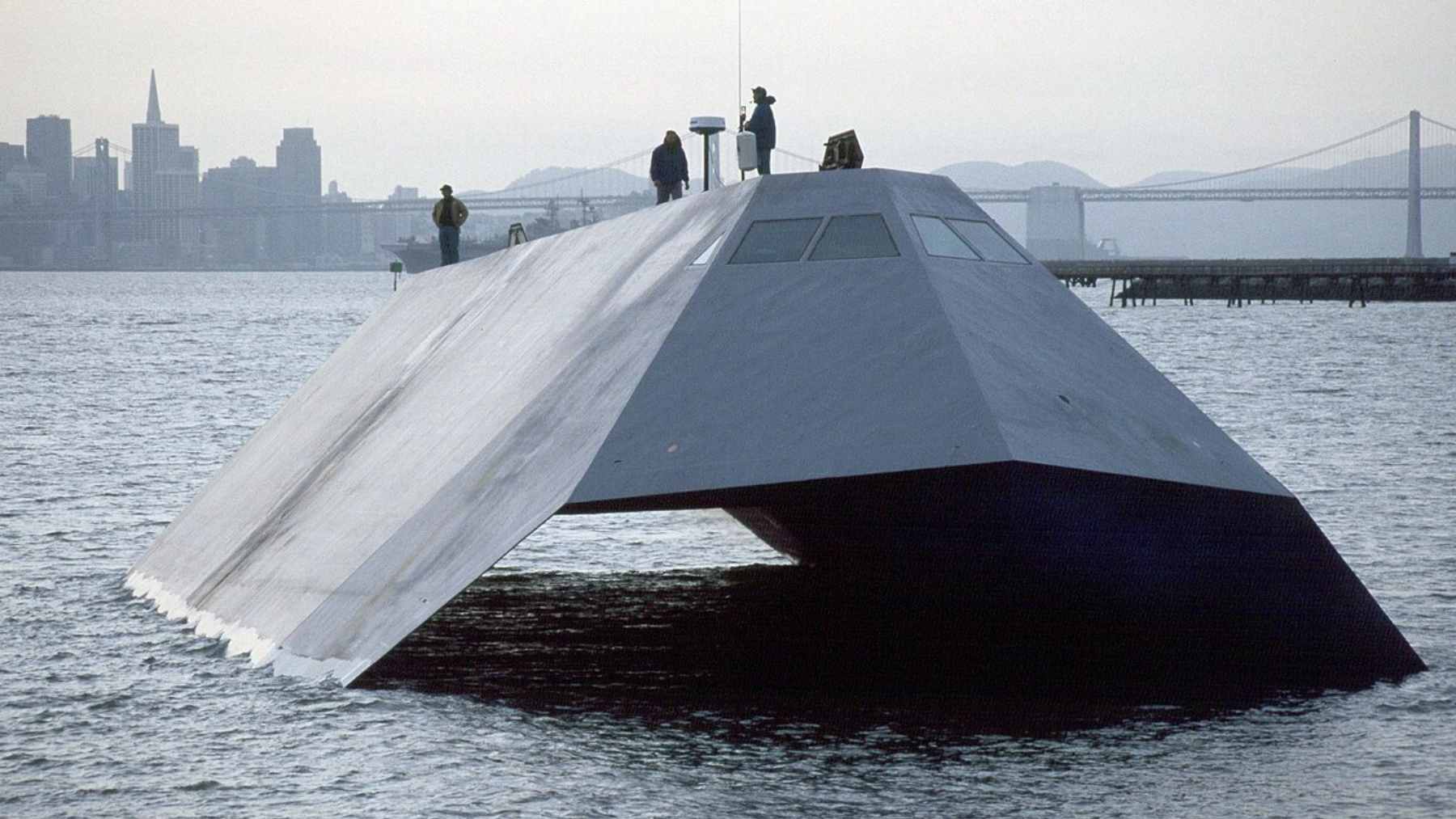 The experimental U.S. Navy stealth vessel Sea Shadow (IX-529) docked in the Hughes Mining Barge (HMB-1).