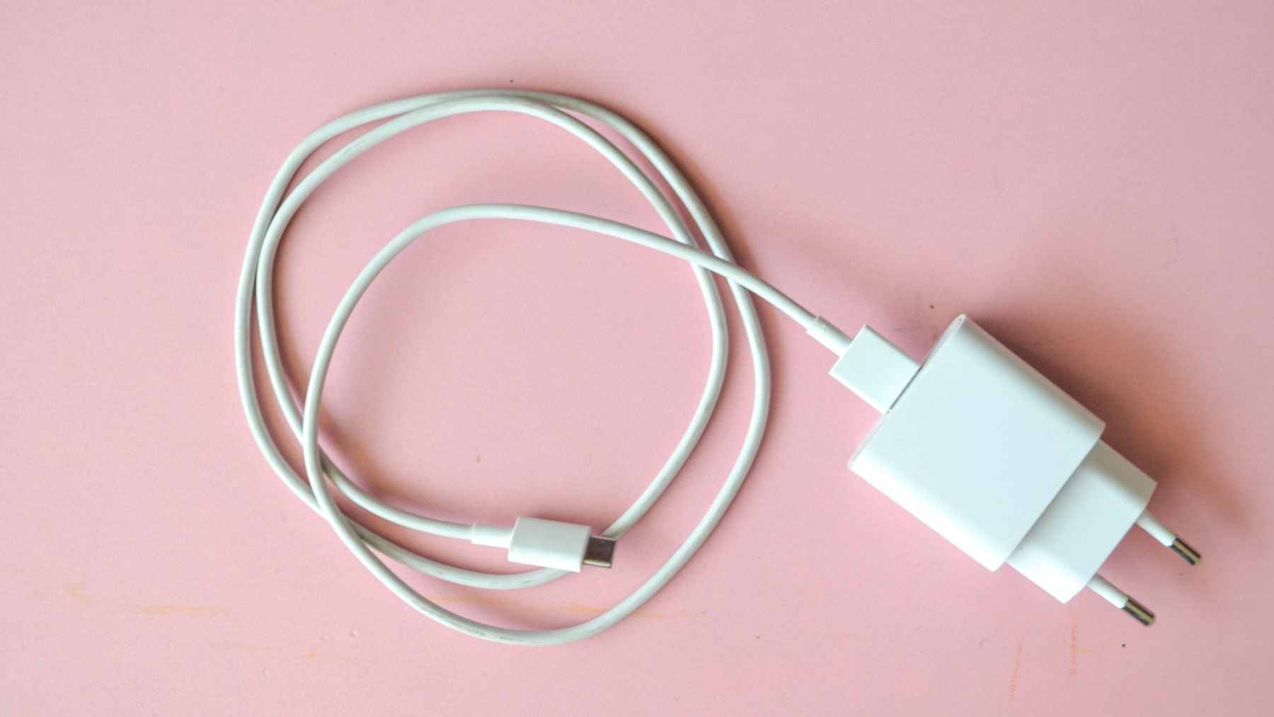 Close-up view of a USB-C connector being plugged into a device, highlighting the complex internal pins that manage power and data.