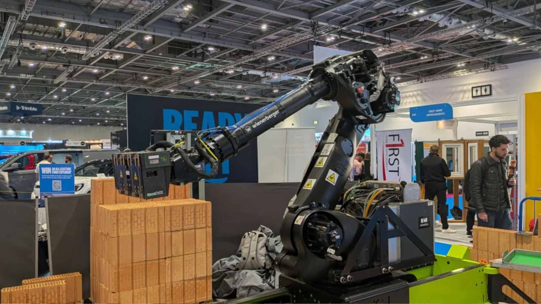 The WLTR masonry robot autonomously laying bricks on a residential construction site using adhesive foam.