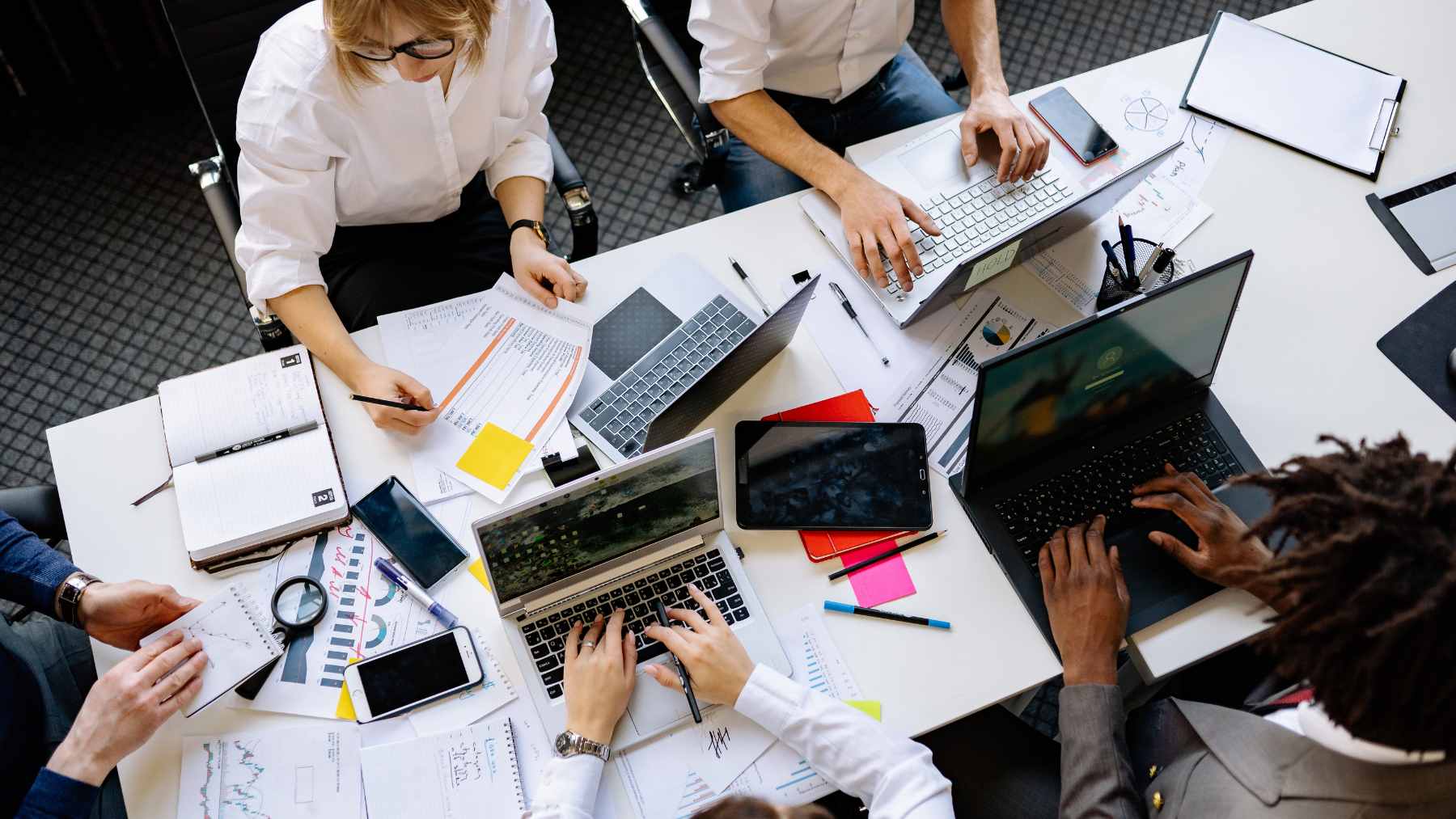 A professional in a modern office using an AI interface on a laptop to automate complex information-processing tasks.