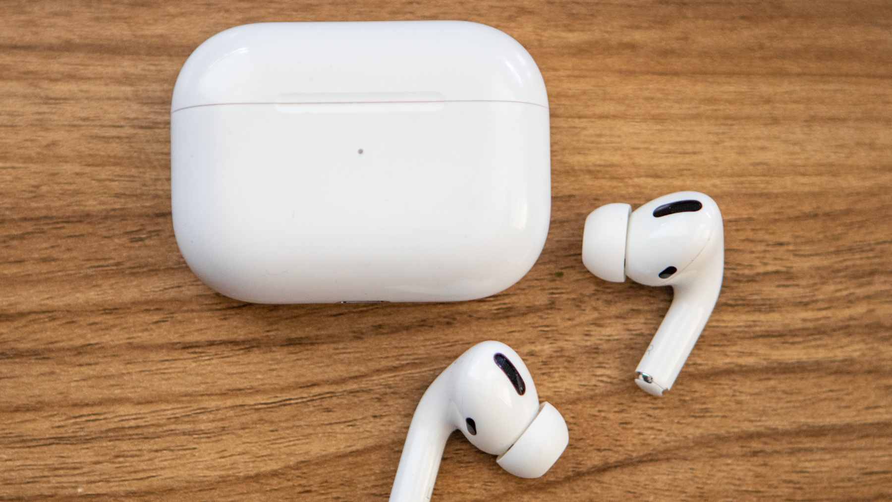 A music fan wearing AirPods Pro during a live concert, utilizing hearing protection features to reduce ambient volume.