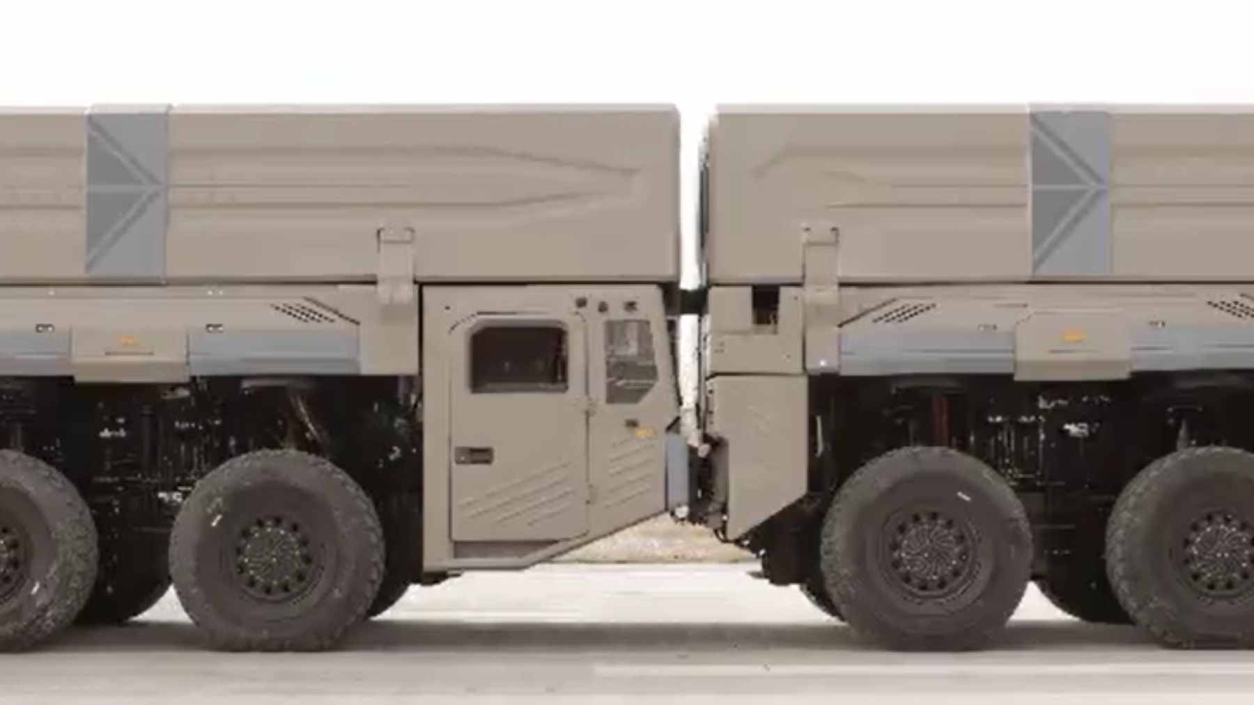 A mobile electromagnetic catapult track mounted on three military trucks to launch fixed-wing drones.