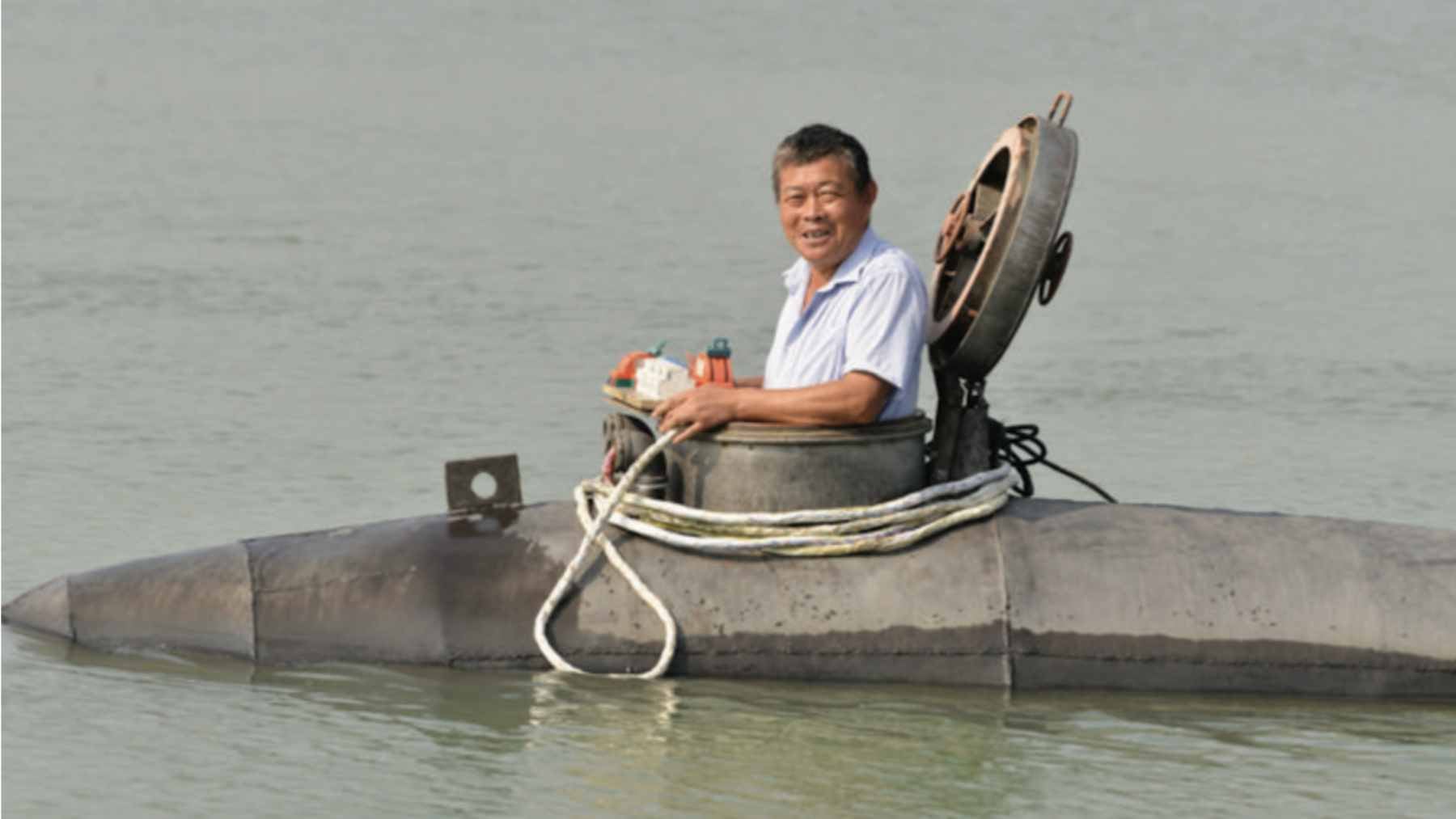 A Chinese farmer in his 60s built an 11,000-pound homemade submarine in his village and launched it into a river in Anhui, as if it were an impromptu naval test 1 Zhang Shengwu piloting his 5-ton homemade submarine, Big Black Fish, during a test dive in a river in Hanshan County, Anhui.