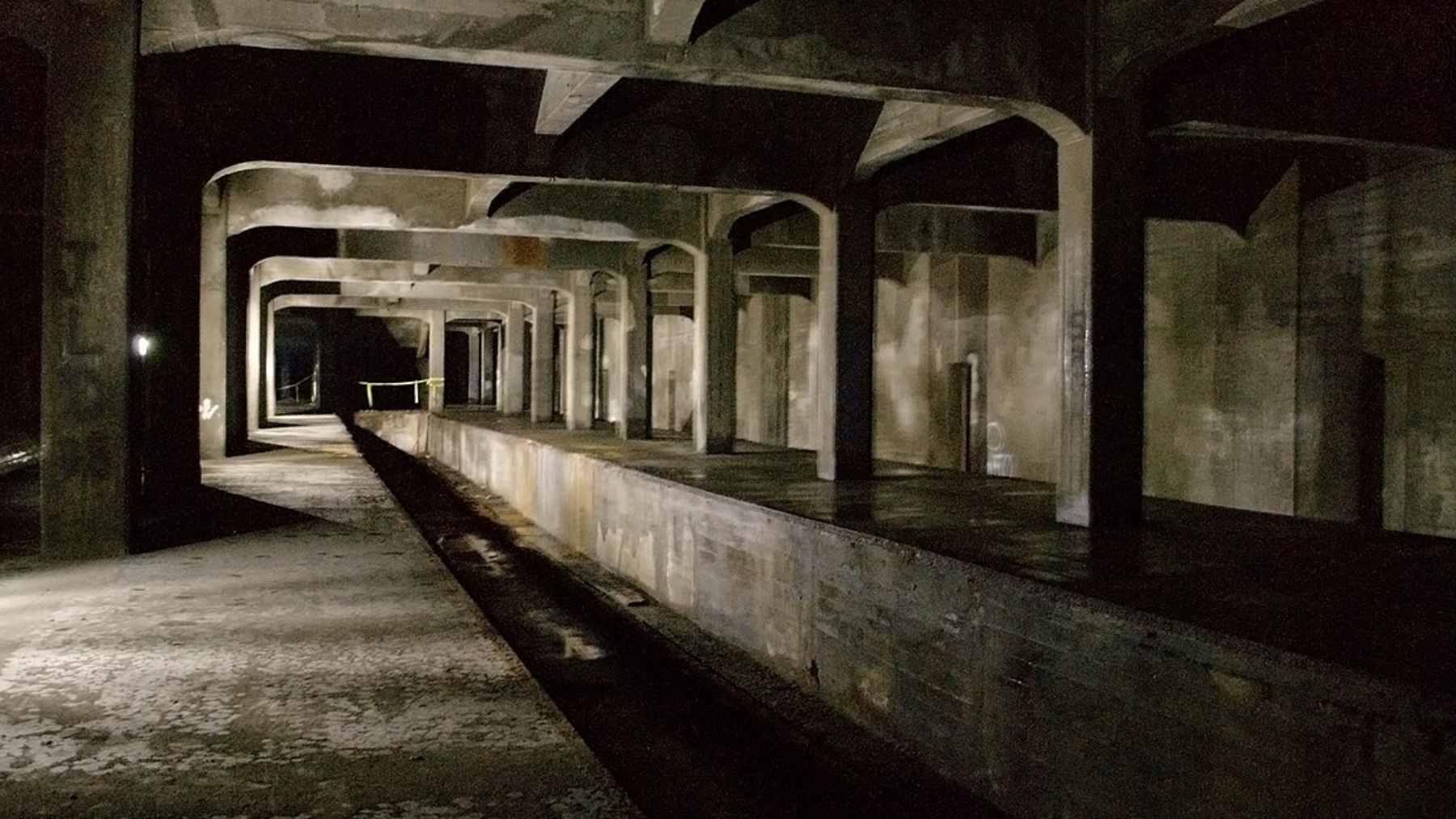 The dark, desolate platform of the unfinished and abandoned Liberty Street subway station in Cincinnati, Ohio.