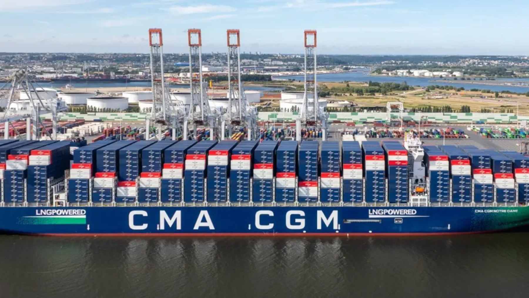 The massive CMA CGM Notre Dame container ship docked at the Port of Le Havre, highlighting its scale and advanced LNG propulsion system.