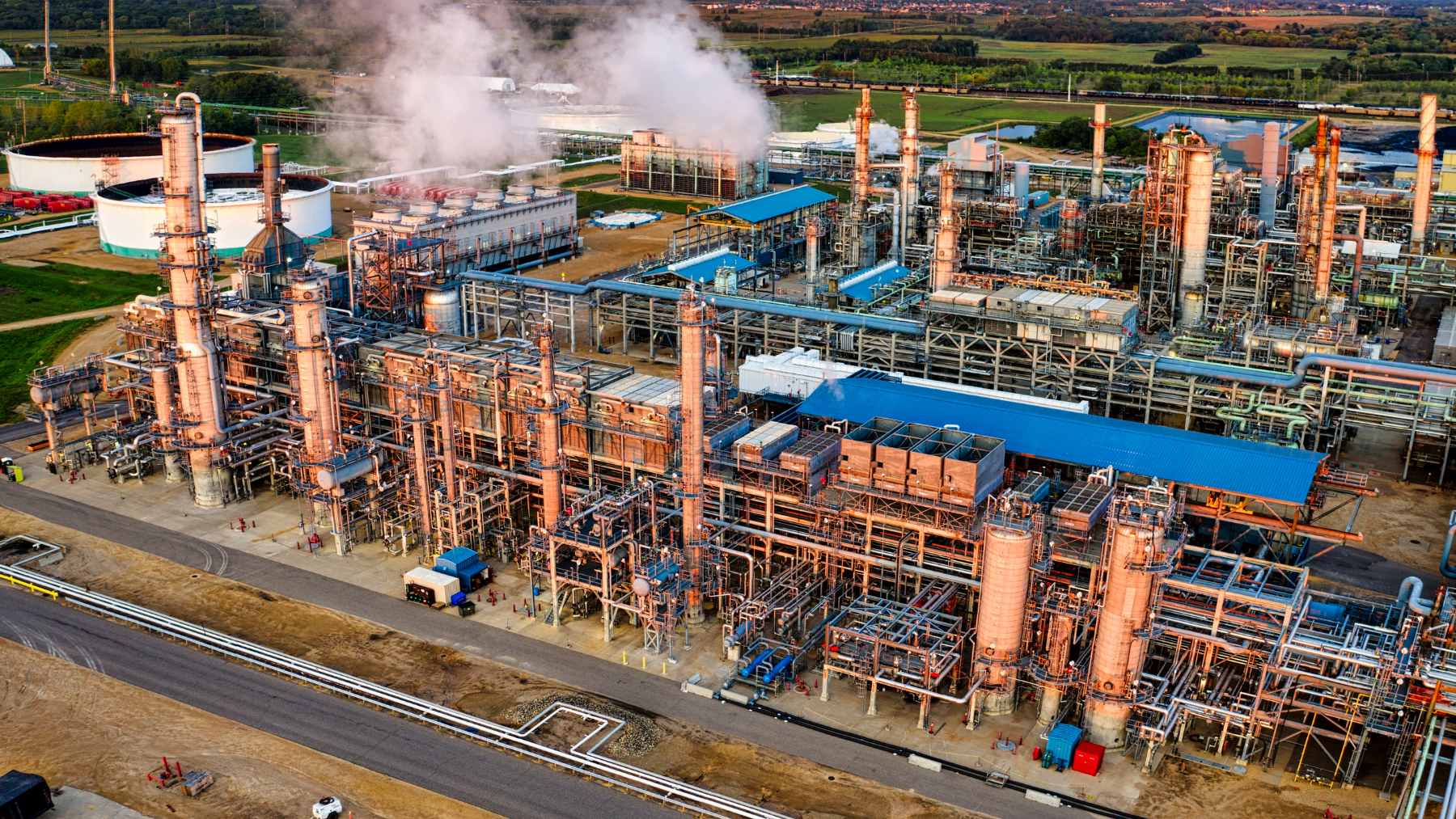 An aerial view of the massive Dangote Petroleum Refinery & Petrochemicals complex in Nigeria, symbolizing the country's push for energy independence.