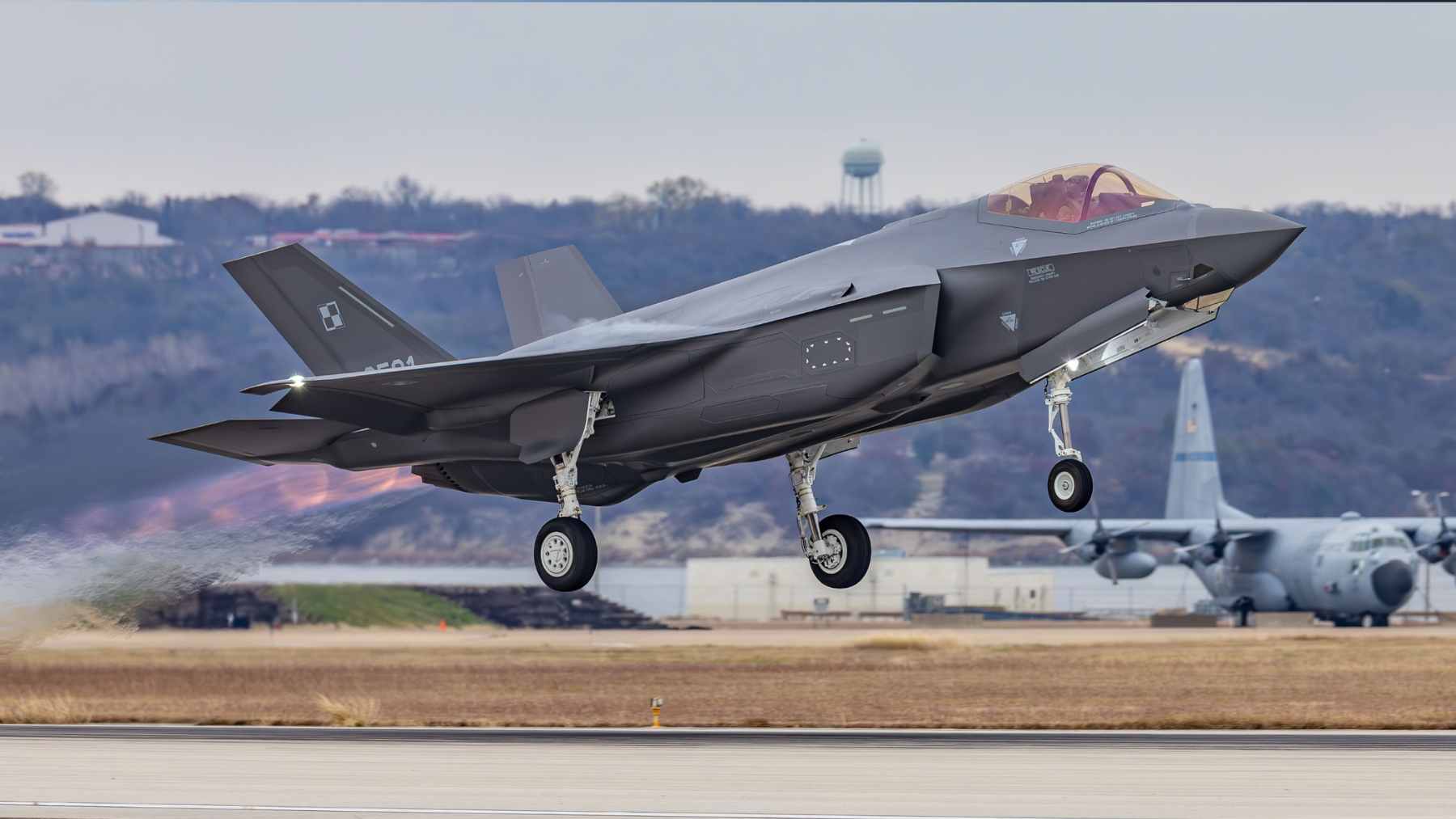 An F-35 pilot wearing the advanced Gen III Helmet Mounted Display System, which provides real-time tactical data and "see-through" cockpit imagery.
