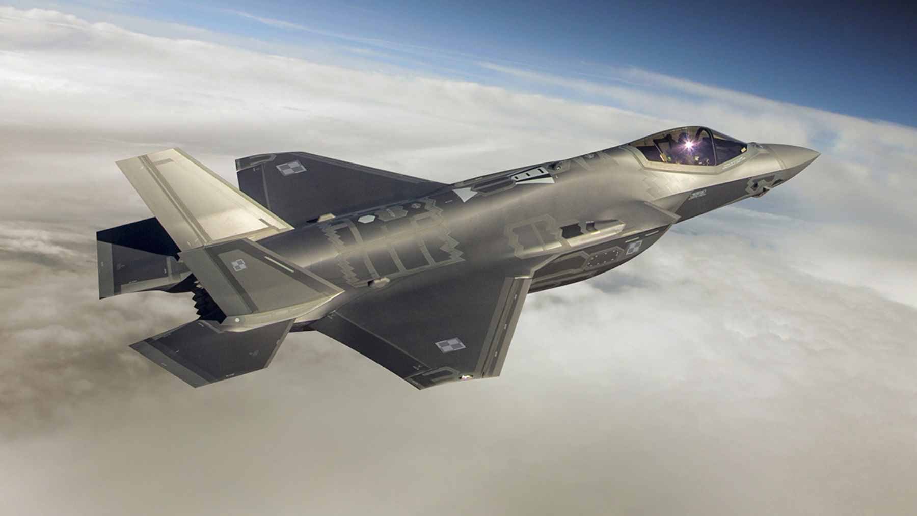 An F-35 pilot wearing the advanced Gen III Helmet Mounted Display System, which provides real-time tactical data and "see-through" cockpit imagery.