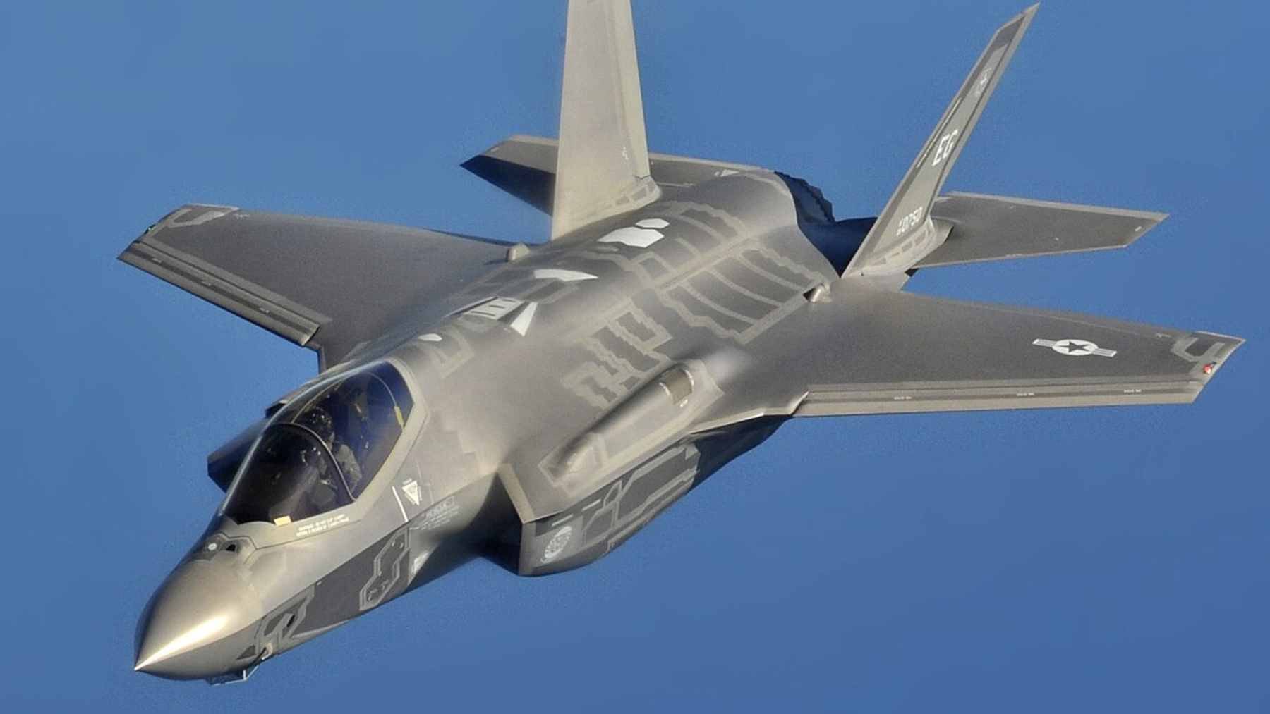 A Lockheed Martin F-35A Lightning II stealth fighter performing a high-speed flyby, marking the transition to fifth-generation air superiority.