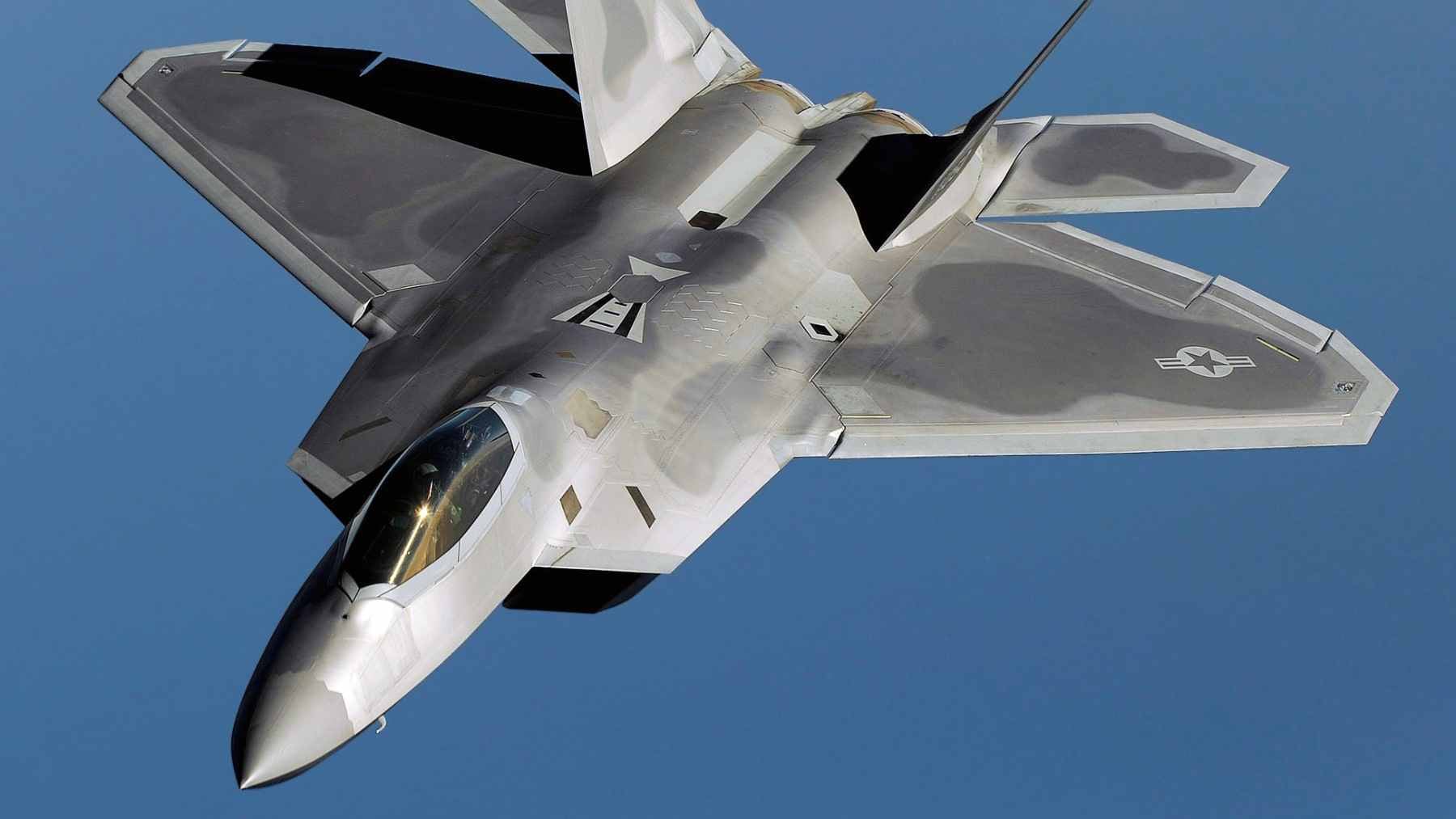 A single software update to the F-22's engine is quietly keeping America's stealth fighter combat-ready into the 2040s, and almost no one noticed 2 A maintenance crew working on a Pratt & Whitney F119 engine inside an F-22 Raptor, emphasizing the shift toward data-driven, usage-based sustainment.