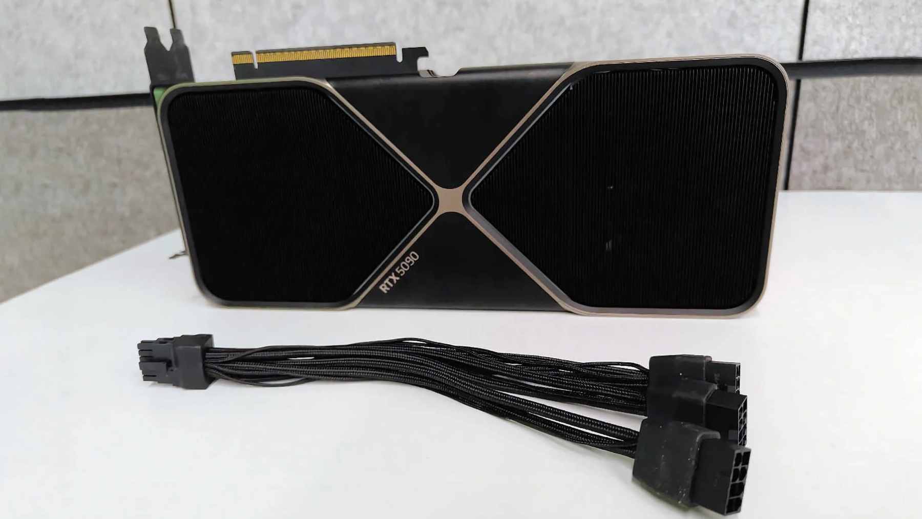 A man opened his RTX 5090 to find fans spinning at 2000 RPM and thermal paste smeared across the board, and what it reveals after one year is damning 1 A disassembled AORUS RTX 5090 graphics card showing uneven application and migration of thermal conductive gel inside the cooling assembly.