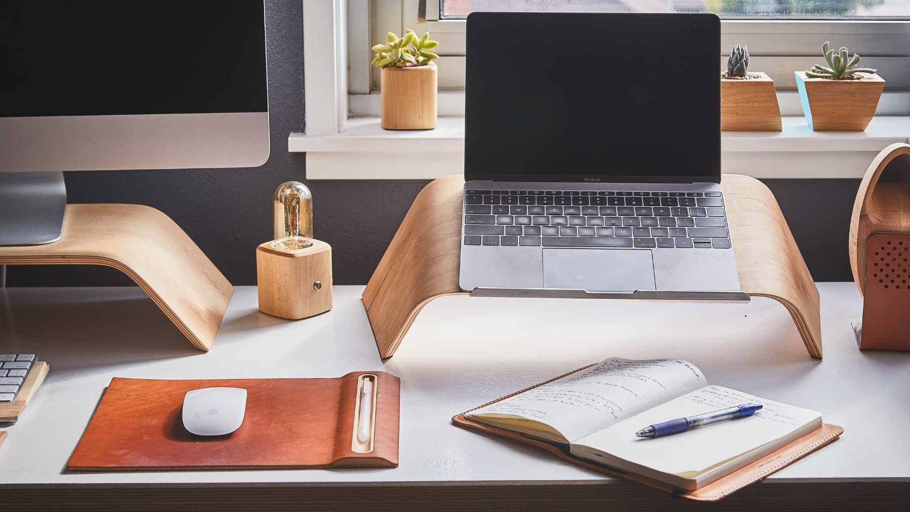 Twelve gadgets under $25 that could quietly fix the home office you threw together on the fly 1 An organized home office desk setup featuring a laptop stand, external keyboard, mouse, and affordable tech accessories.