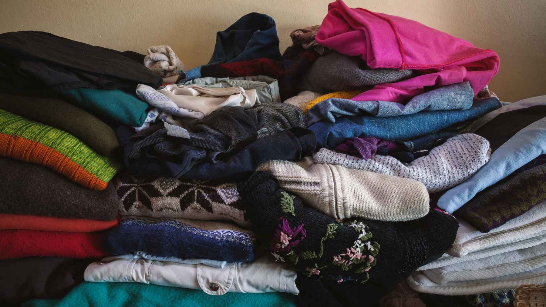 You trade old clothes for steel bowls: the hidden supply chain that decides where those clothes really go 2 A traditional community market scene showing used clothing bundles and household textiles, representing India's informal circular economy and textile recycling supply chain.