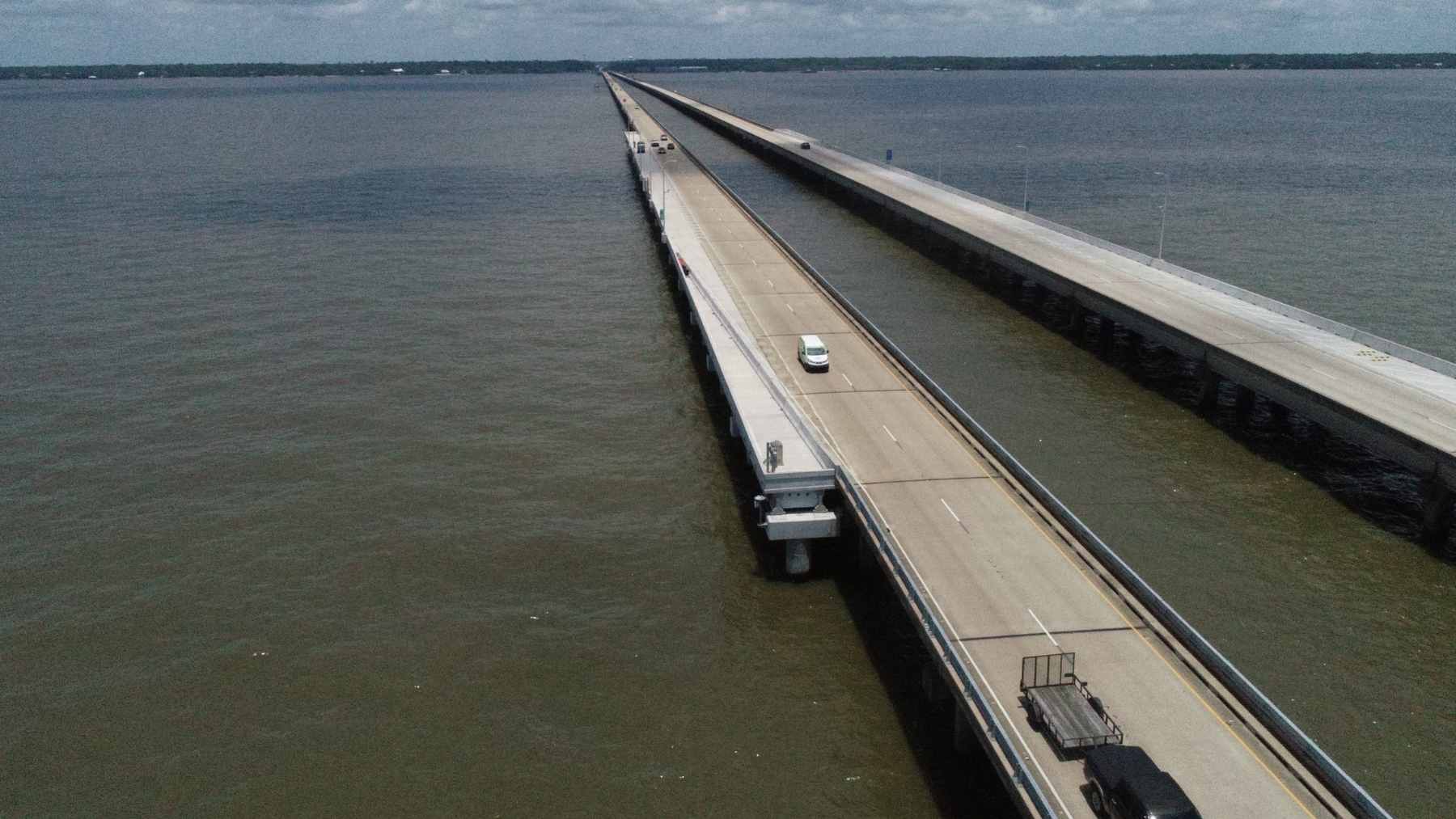 The longest bridge in the United States stretches so far over water that for miles you can't see land 1 An aerial view of the twin spans of the Lake Pontchartrain Causeway stretching across the horizon in Louisiana.