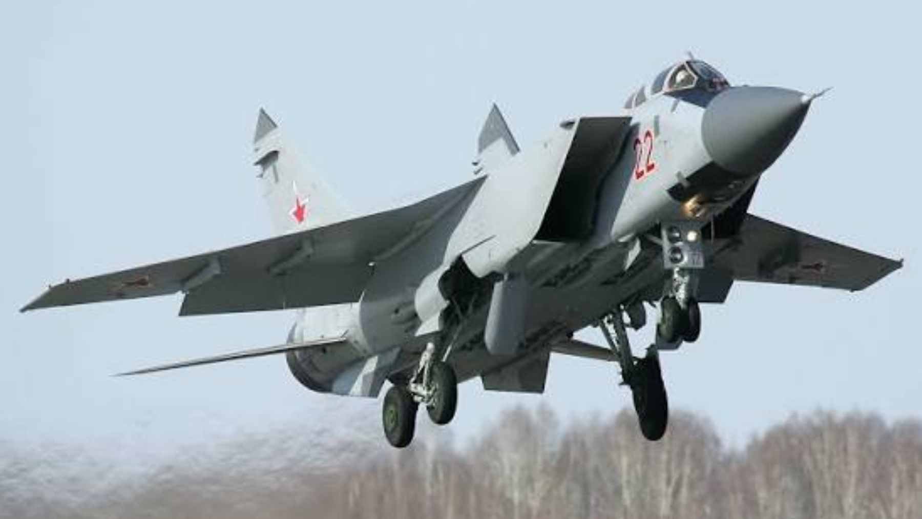A Russian MiG-31BM Foxhound interceptor cruising over Arctic waters during a long-range strategic patrol.
