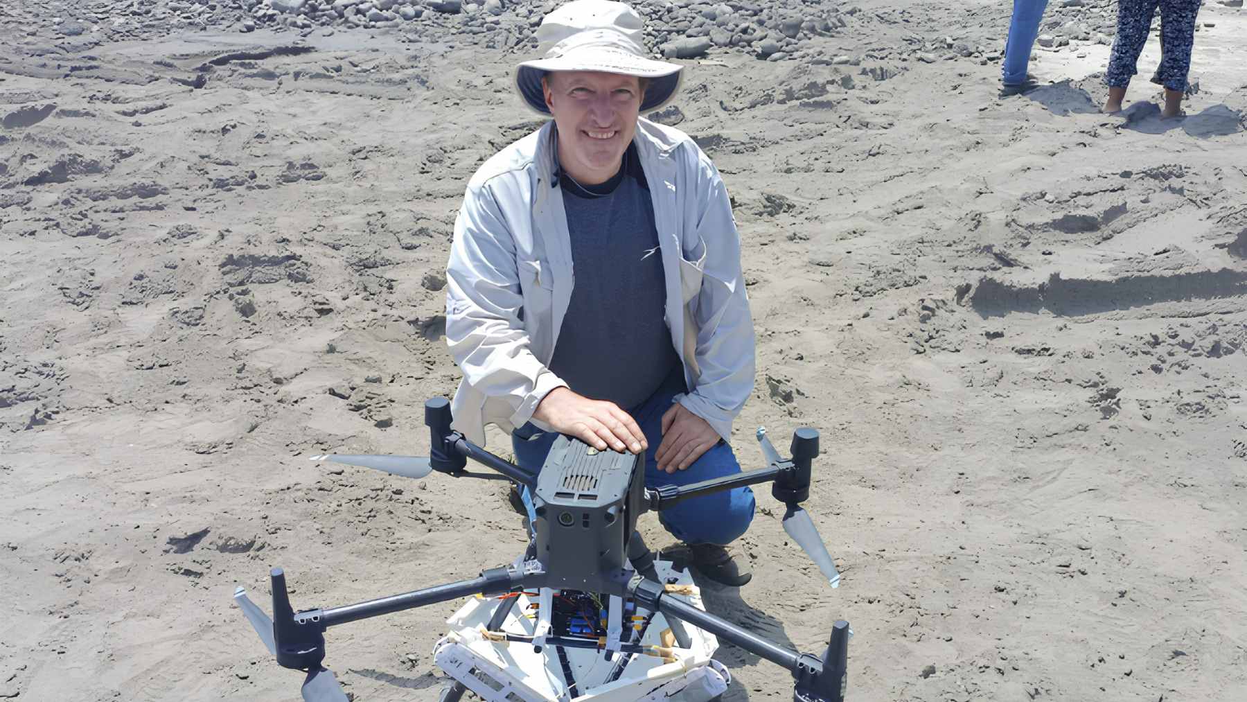 A former NASA engineer built drones that 'plant' 40 million trees a year across the Amazon and California 2 A reforestation drone hovering over a damaged landscape, preparing to deploy seed balls designed to restore native vegetation.