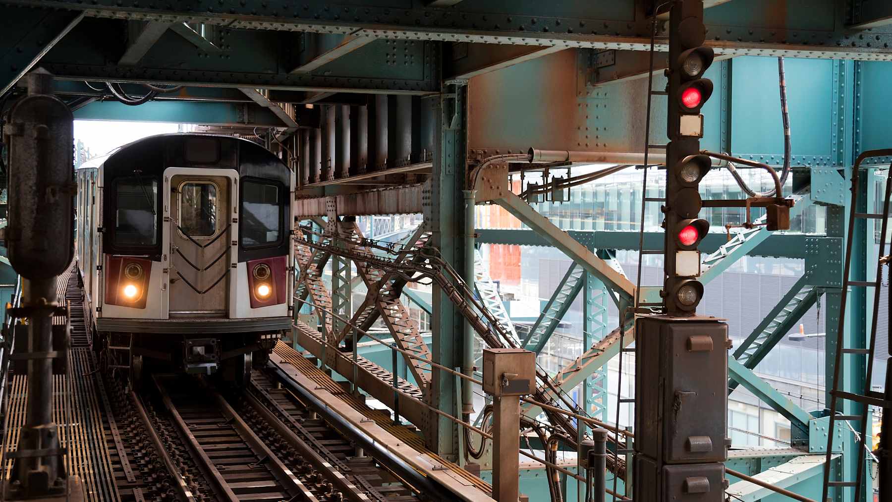 A digital monitor on a New York City subway platform displaying an AI-generated overlay tracking movement near the yellow safety line.