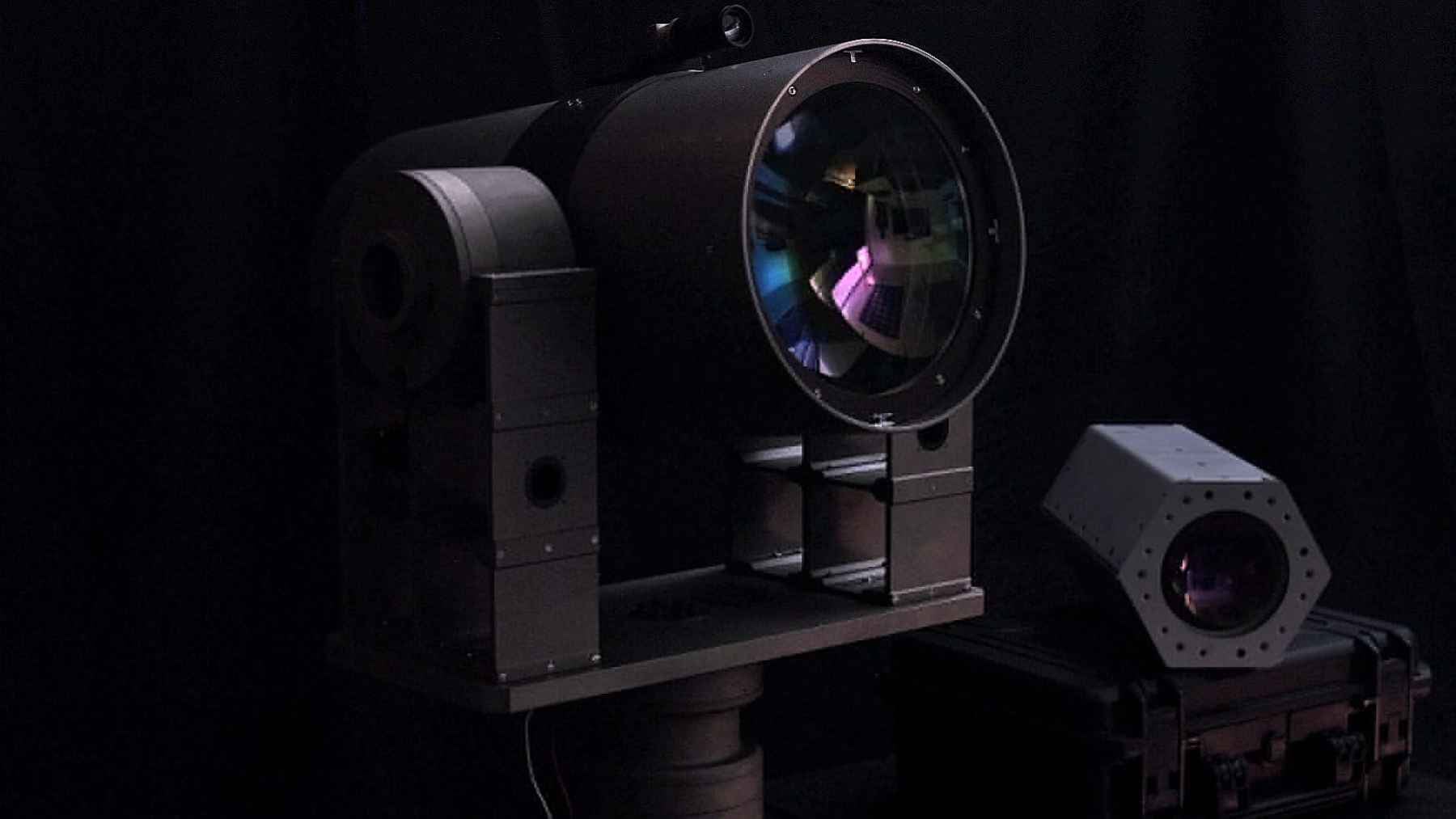 A directed-energy laser defense system emitter used for optical sensor blinding and counter-drone missions, representing NUBURU's testing with Tekne.