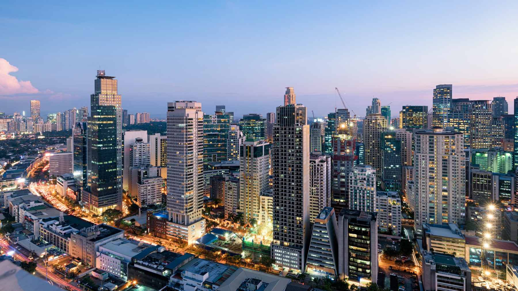 Rows of residential rooftop solar panels installed in a dense urban neighborhood in the Philippines to combat rising utility costs.