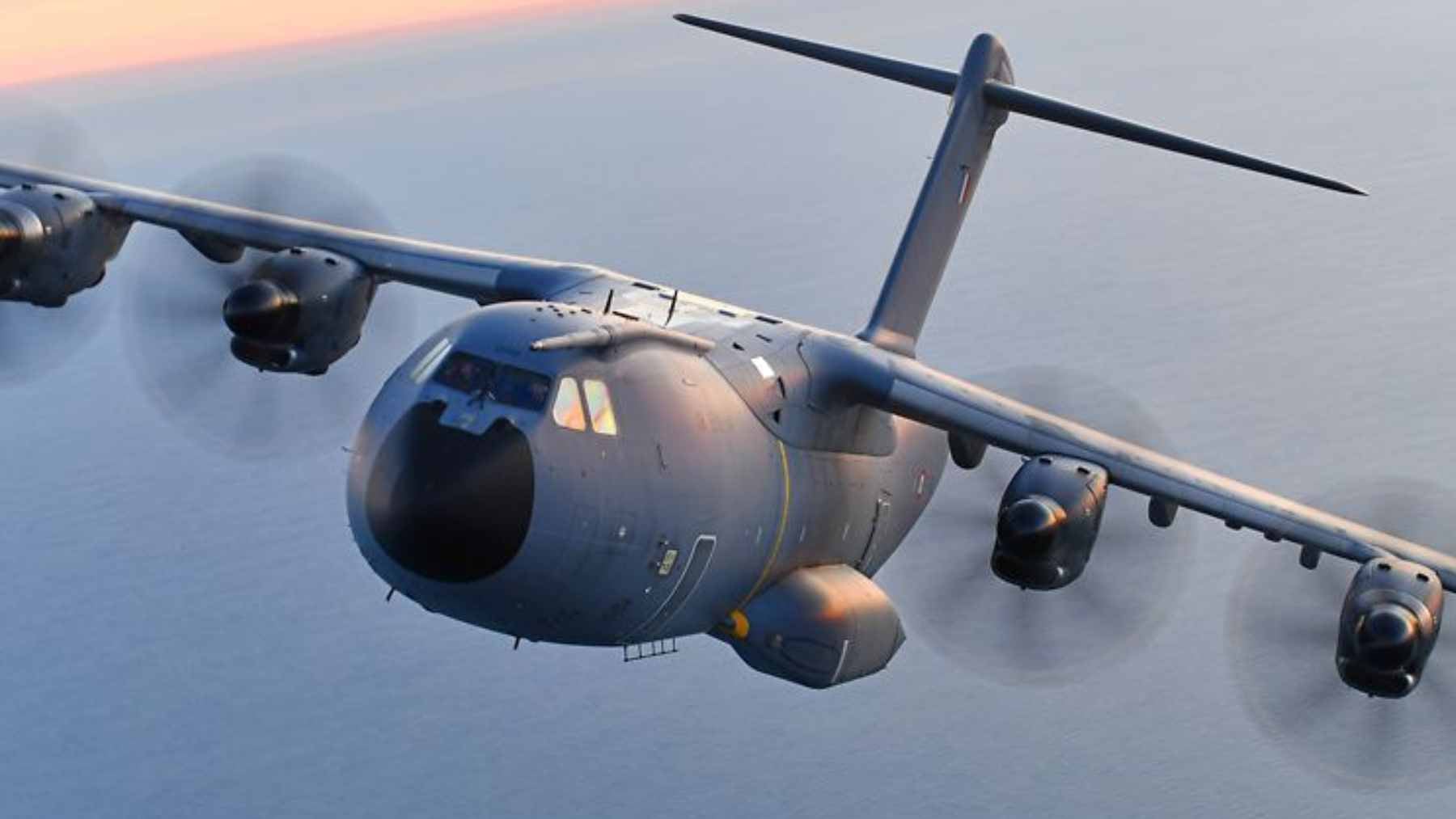 An Airbus A400M military transport aircraft flying in the sky during a flight demonstration.