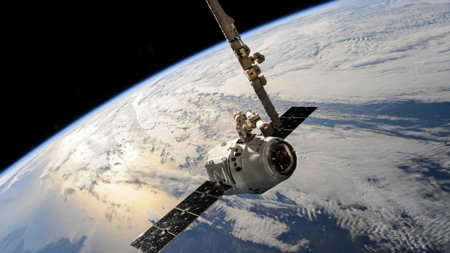 A digital illustration of satellites orbiting Earth, highlighting the constant turnover and atmospheric reentry of megaconstellations.