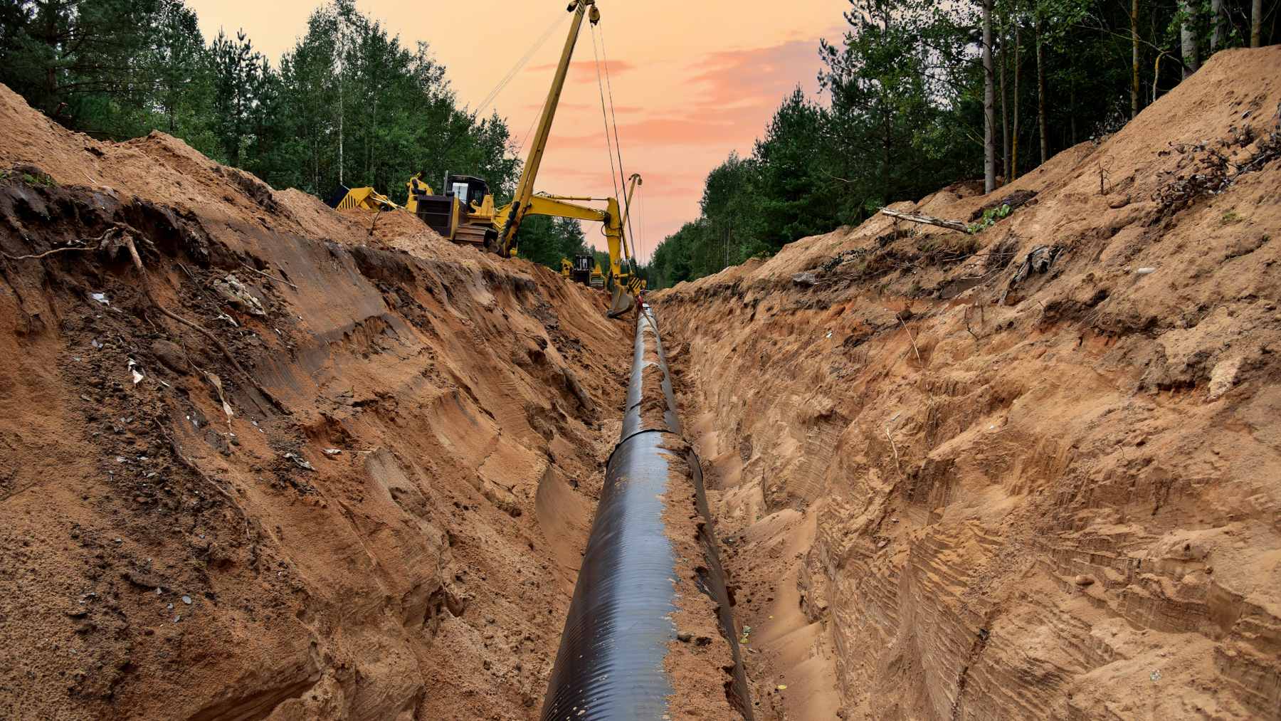 Construction equipment working near the SpaceX Starbase facility in Texas, where the new Starpipe natural gas pipeline is being laid to support increased Starship launch operations.