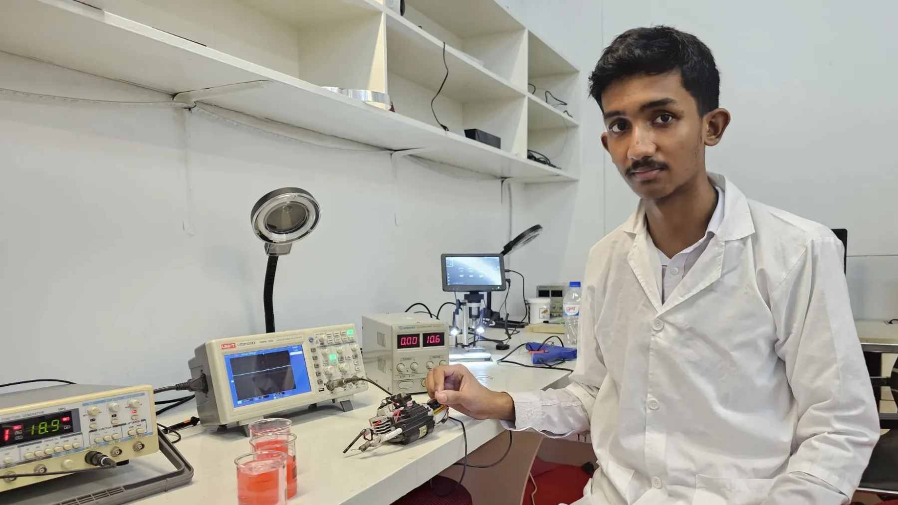 A functional water purification prototype built by Zabeer Zarif Akhter using recycled circuit boards, laptop batteries, and solar components.