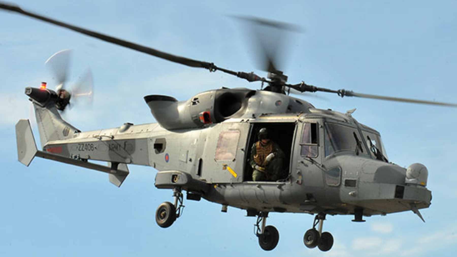 Britain's Wildcat helicopters entered service barely a decade ago, and they're already being quietly replaced by drones 1 A British Army Wildcat AH1 helicopter performing reconnaissance training over a rural landscape.