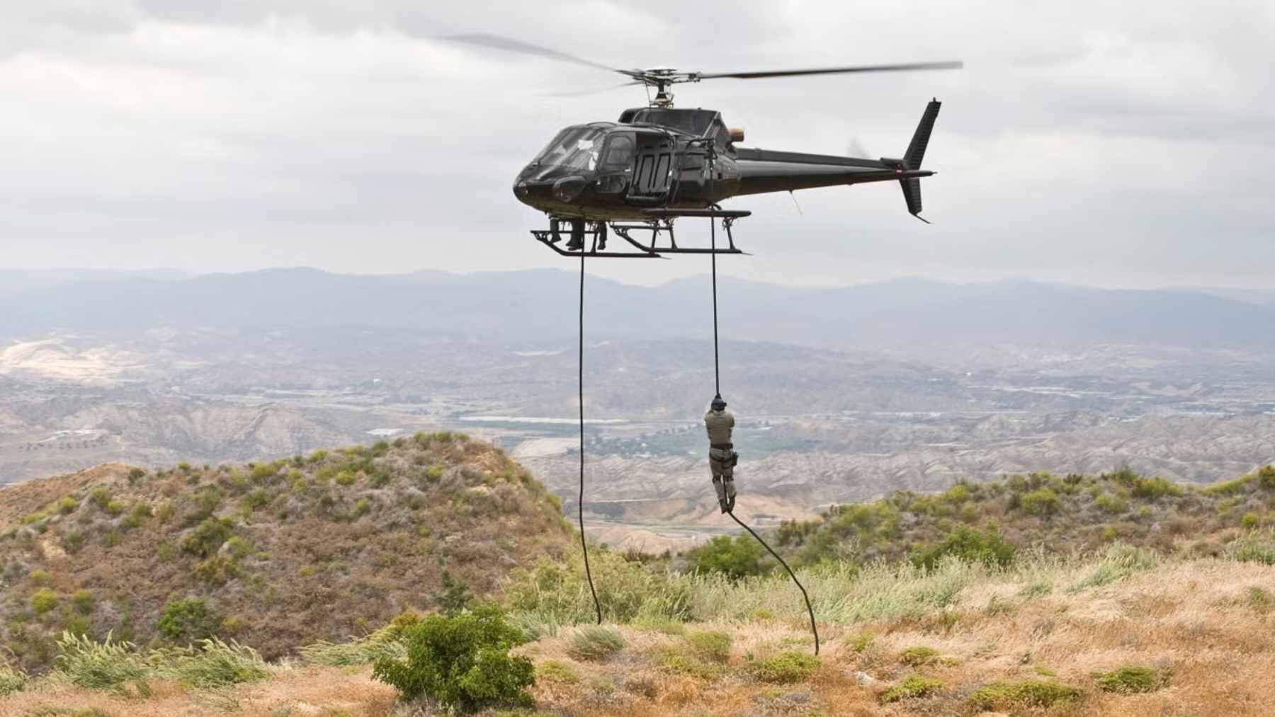 US Customs keeps turning to Airbus H125 Ecureuil helicopters: the border workhorse hiding in plain sight 2 An Airbus H125 helicopter flying over a landscape, representing the light single-engine rotorcraft added to the US Customs and Border Protection fleet.