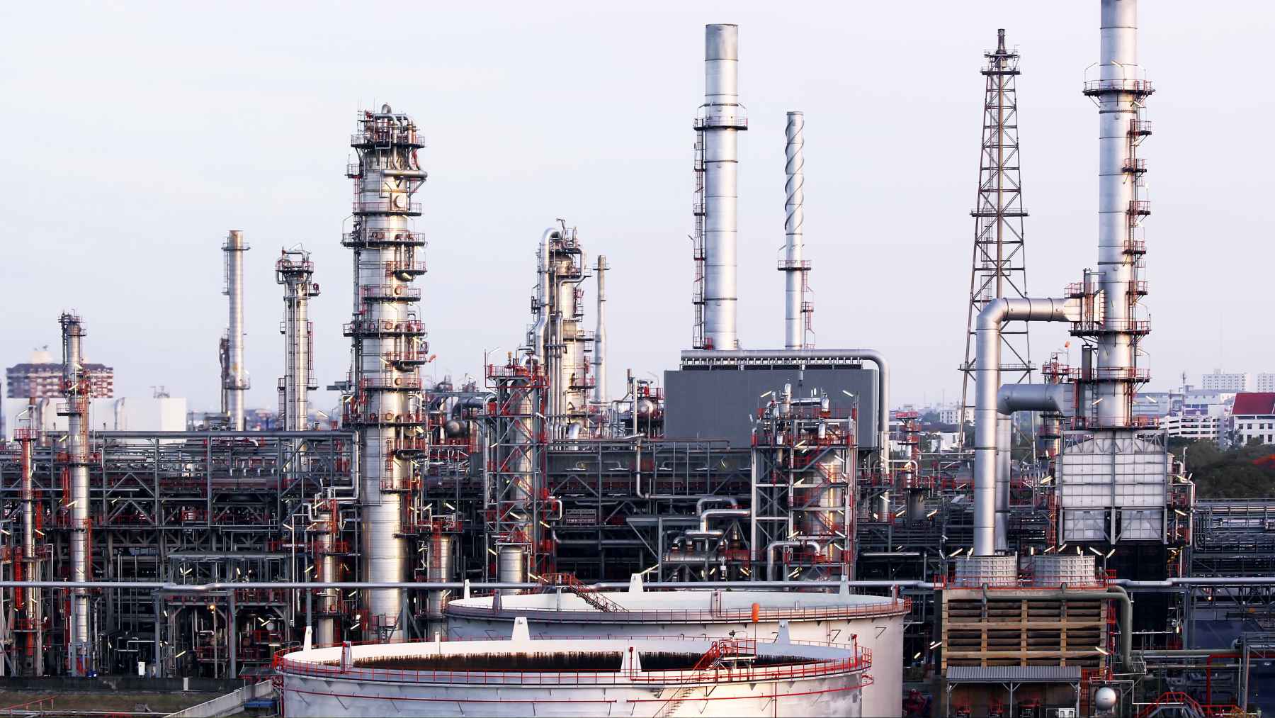 Industrial crude oil refinery processing towers and piping in Chattogram, representing energy infrastructure and financing in Bangladesh.