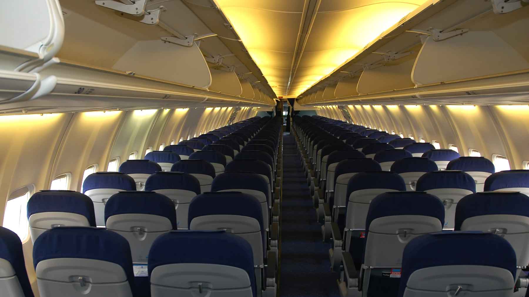 US regulators say seats on hundreds of Boeing 737 MAX jets were installed the wrong way 1 Close-up of commercial airliner passenger seats and floor track mountings inside a cabin.