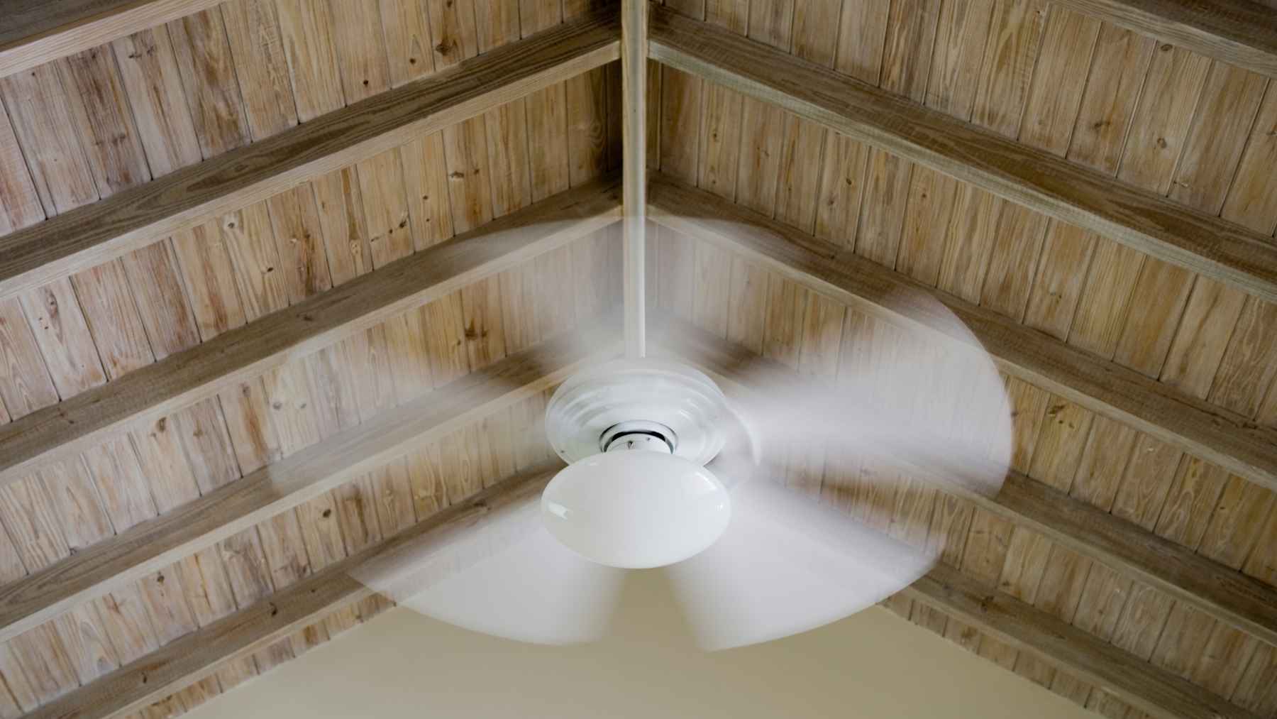 Running a ceiling fan with the AC sounds wasteful, but experts say it actually cuts your power bill 1 A modern ceiling fan spinning in a bright, comfortable living room with an air-conditioned interior.