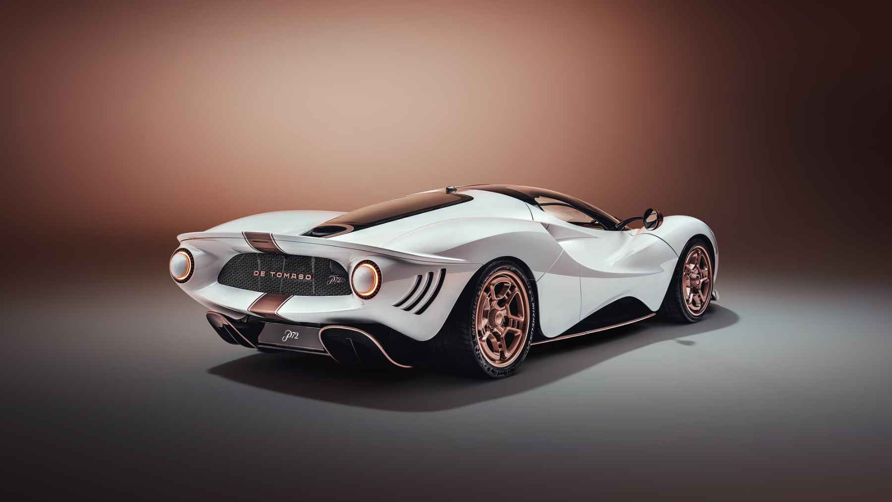 The De Tomaso P72 Aurelian Night supercar driving on European streets, featuring a midnight-blue finish, rose-gold details, and carbon-fiber construction.