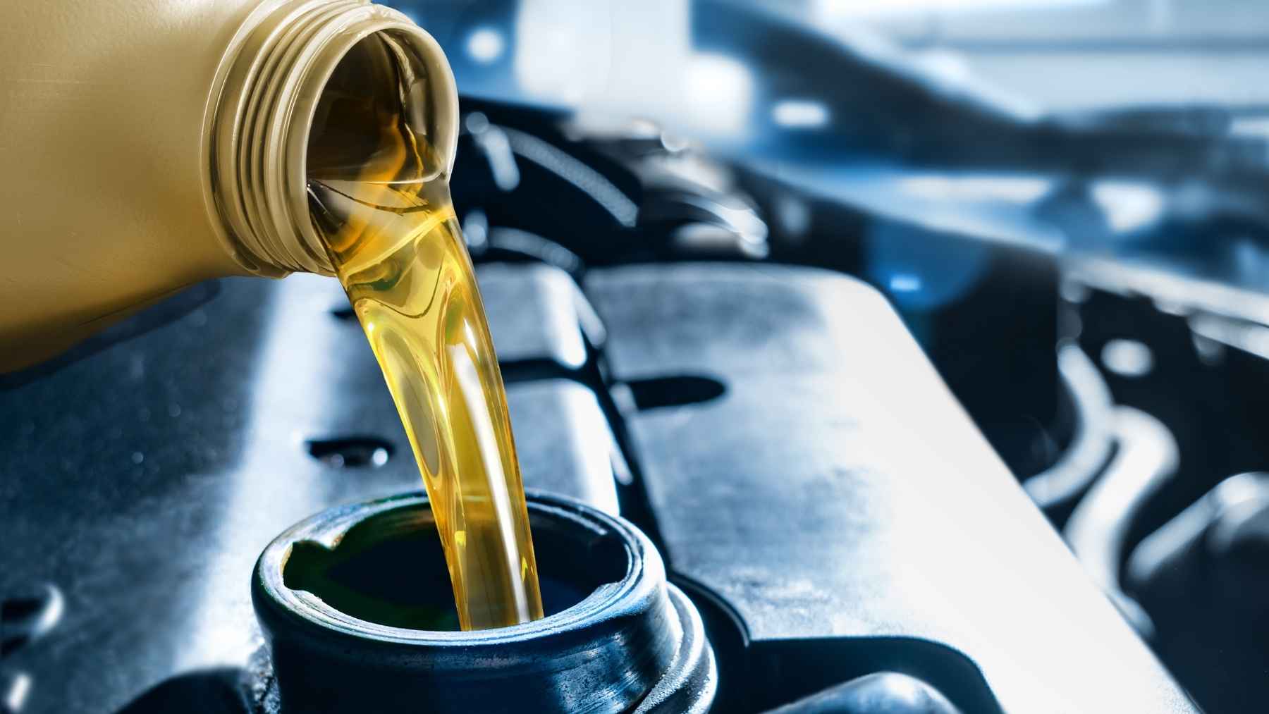 Do the new engine oils shorten an engine's life? One engineer says yes, and his fix has nothing to do with changing brand 2 A technician checking engine oil viscosity and lubricant levels, representing automotive research into low-viscosity oils and engine wear.