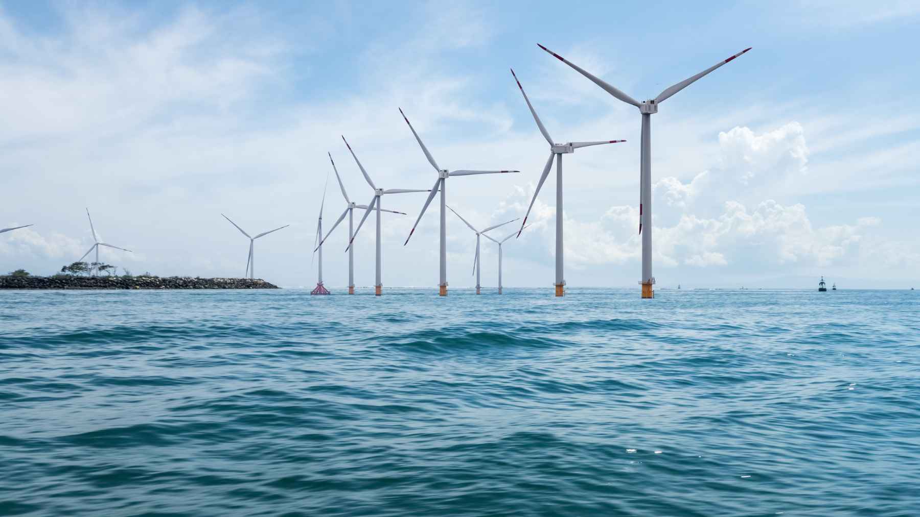 A floating wind farm in the North Sea may be slowing the wind before it even reaches its own blades 1 Massive offshore wind turbines operating in the North Sea under a cloudy sky.