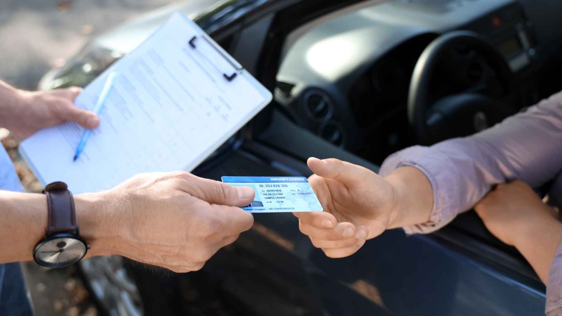 A smartphone displaying a verified digital driving license inside the France Identité app during a roadside traffic stop.