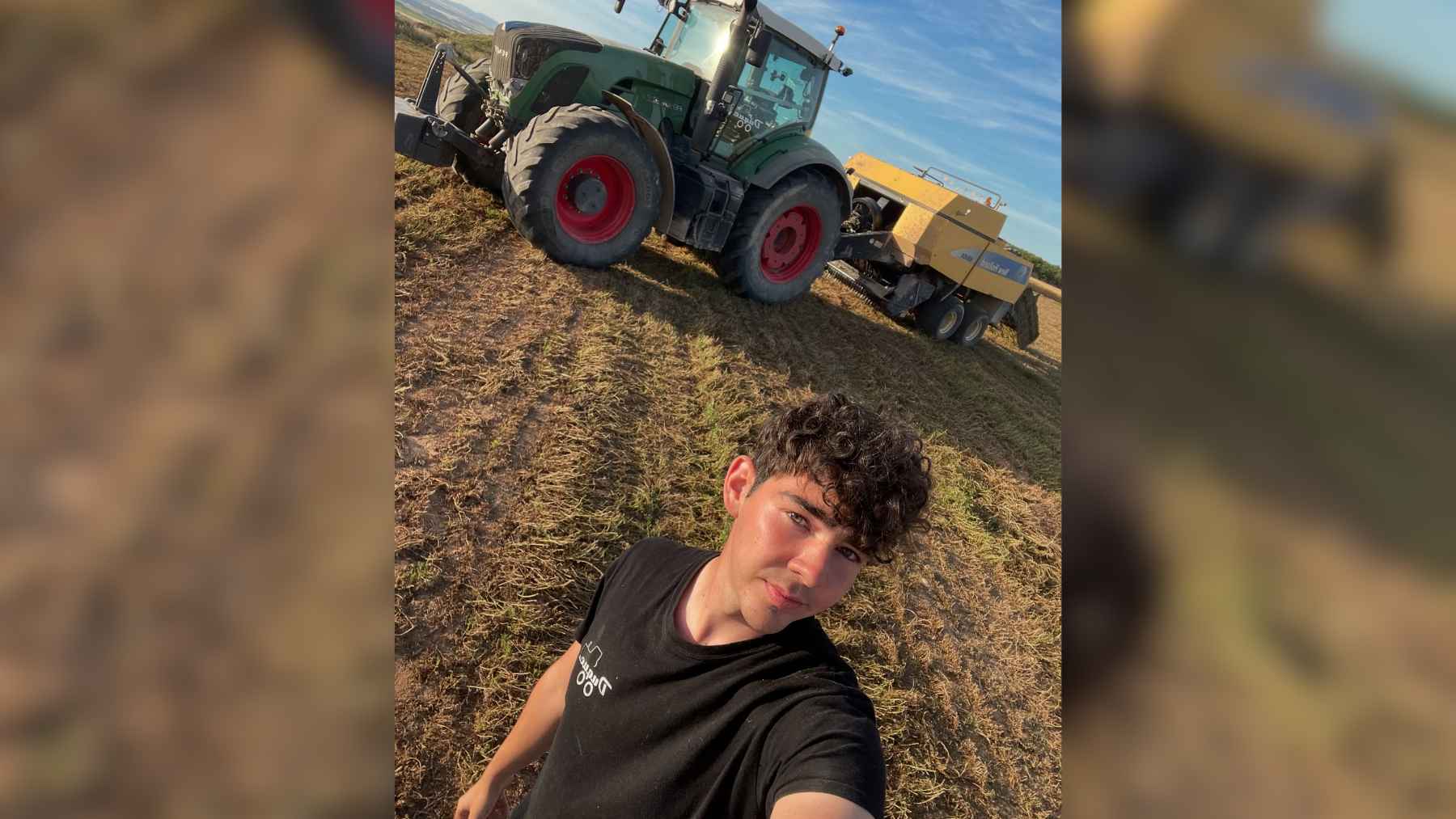 A young farmer standing inside a modern tractor cab in Spain, managing agricultural tech in the fields.