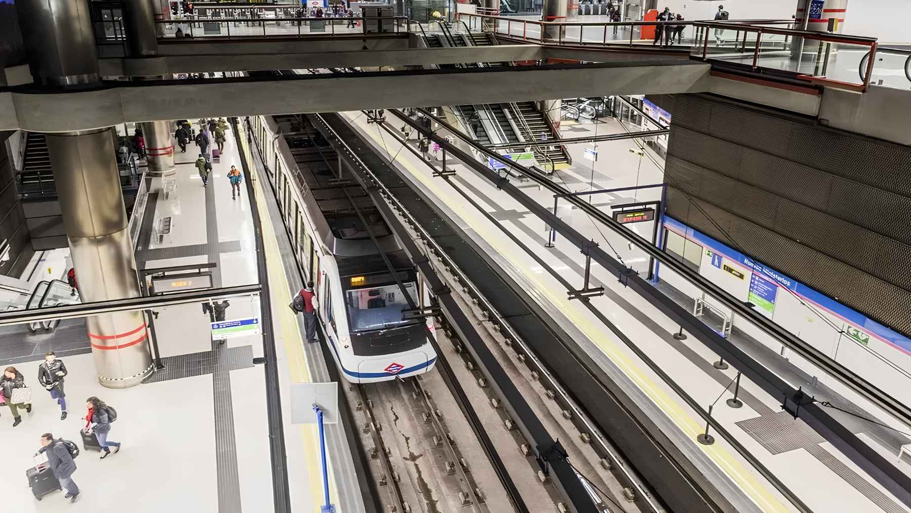Madrid metro station entrance and transit mapping representing regional urban rail expansion.