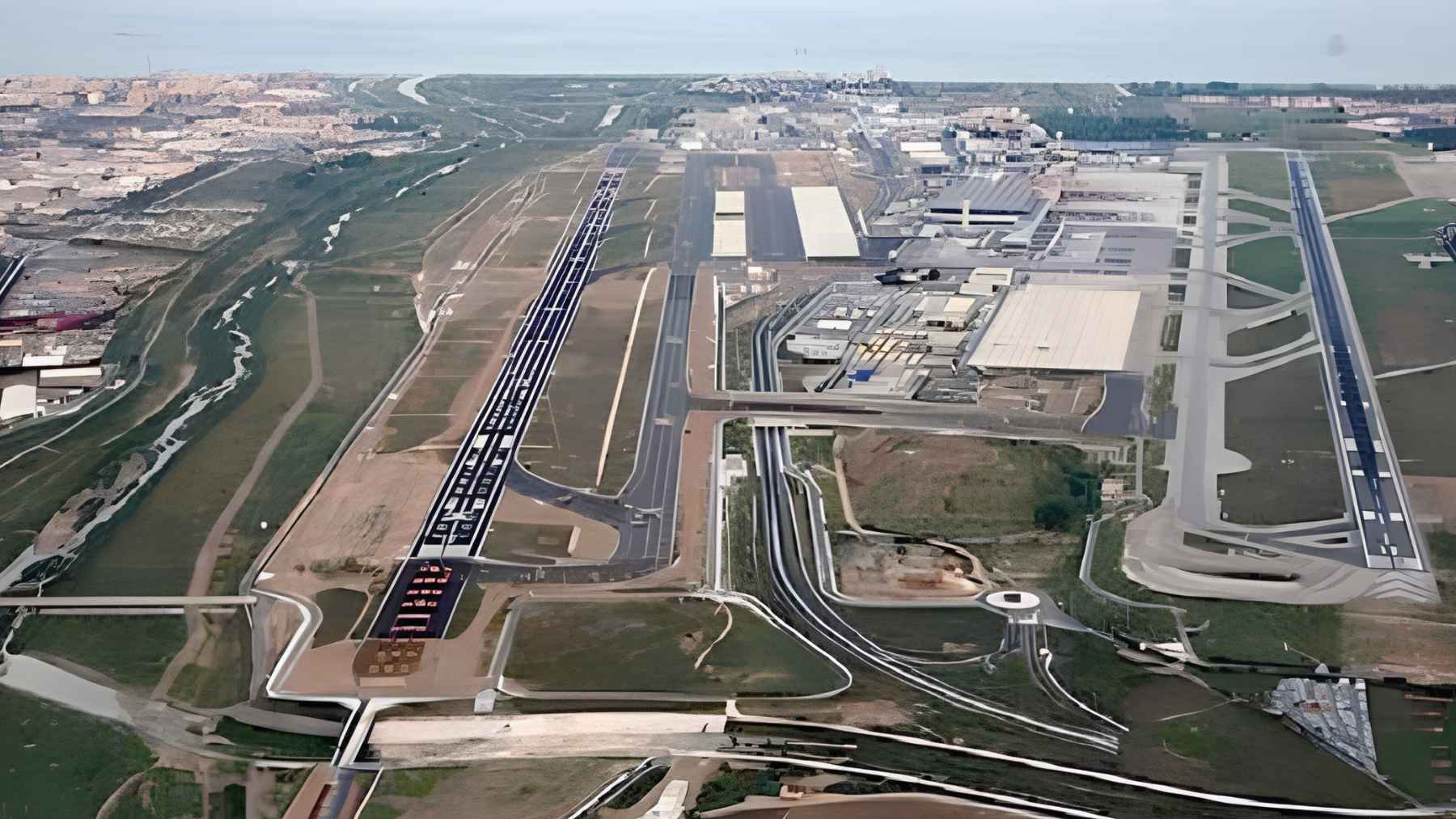 An aerial view of open land and infrastructure near Málaga Airport where the delayed La Loma I logistics park is planned.