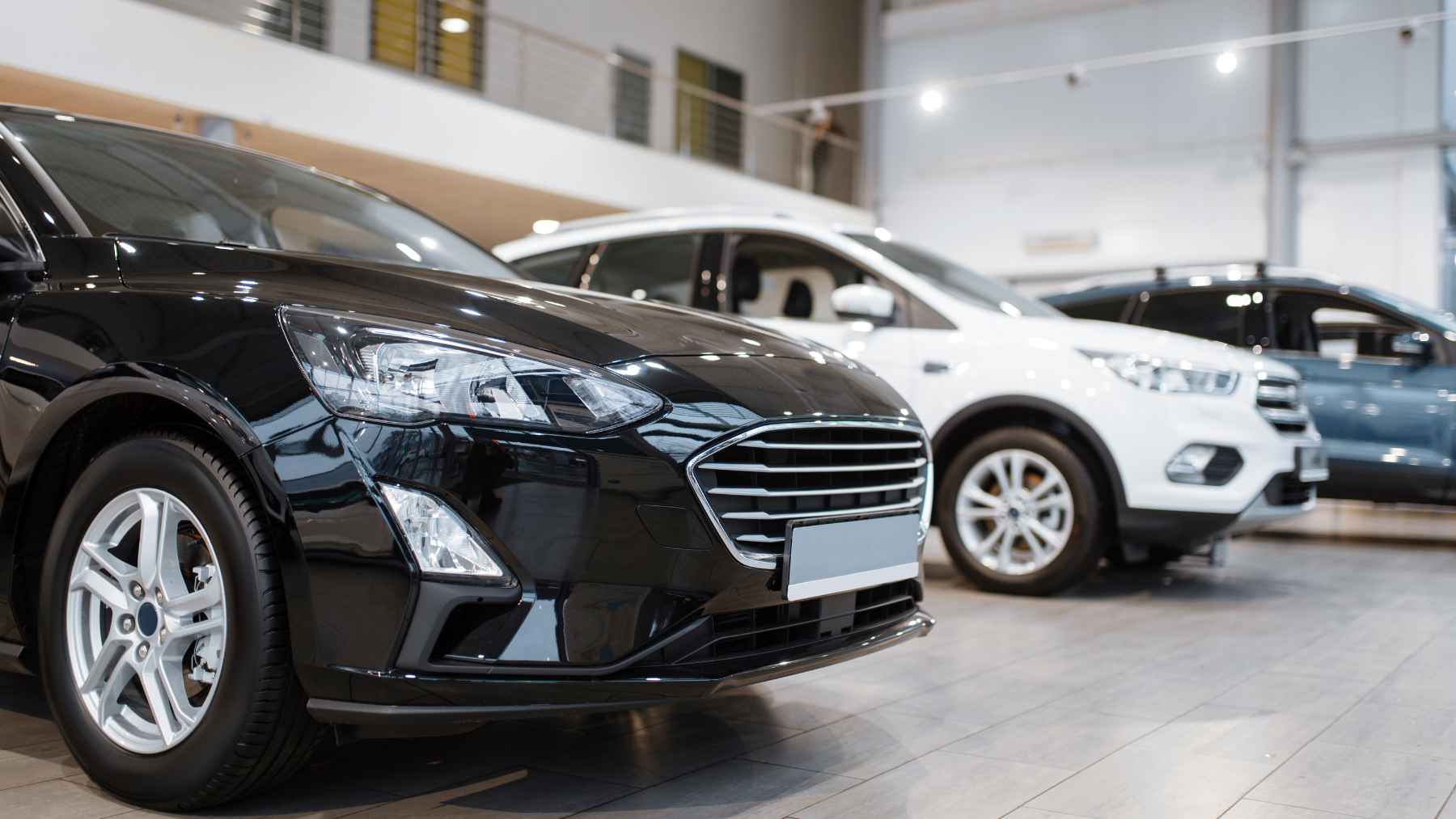 A brand-new car parked on a city street in Mexico, representing vehicles sold with decade-old engineering platforms.