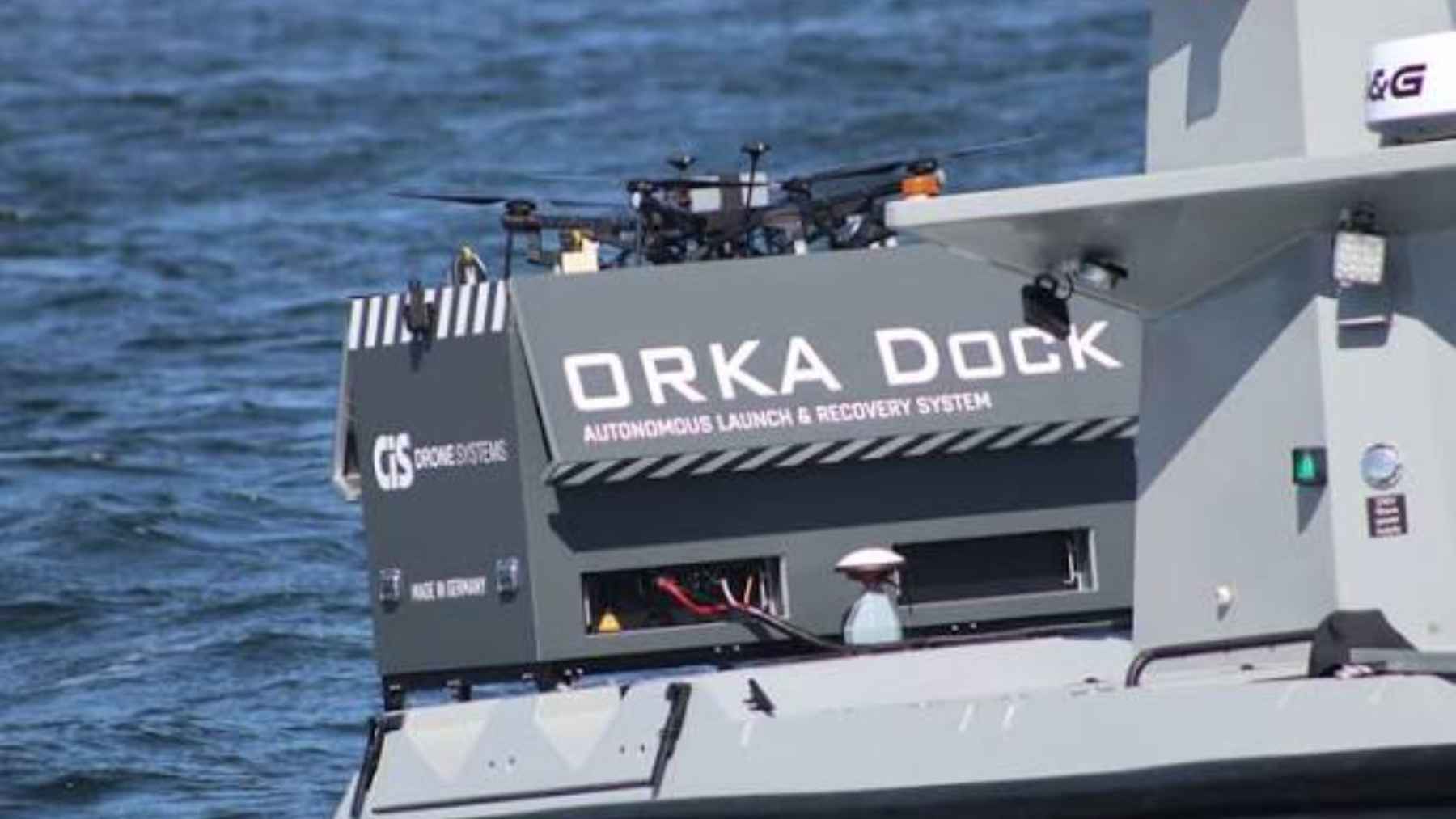An ORKA dock automated launch box mounted on the stern deck of a crewless surface vessel at sea.