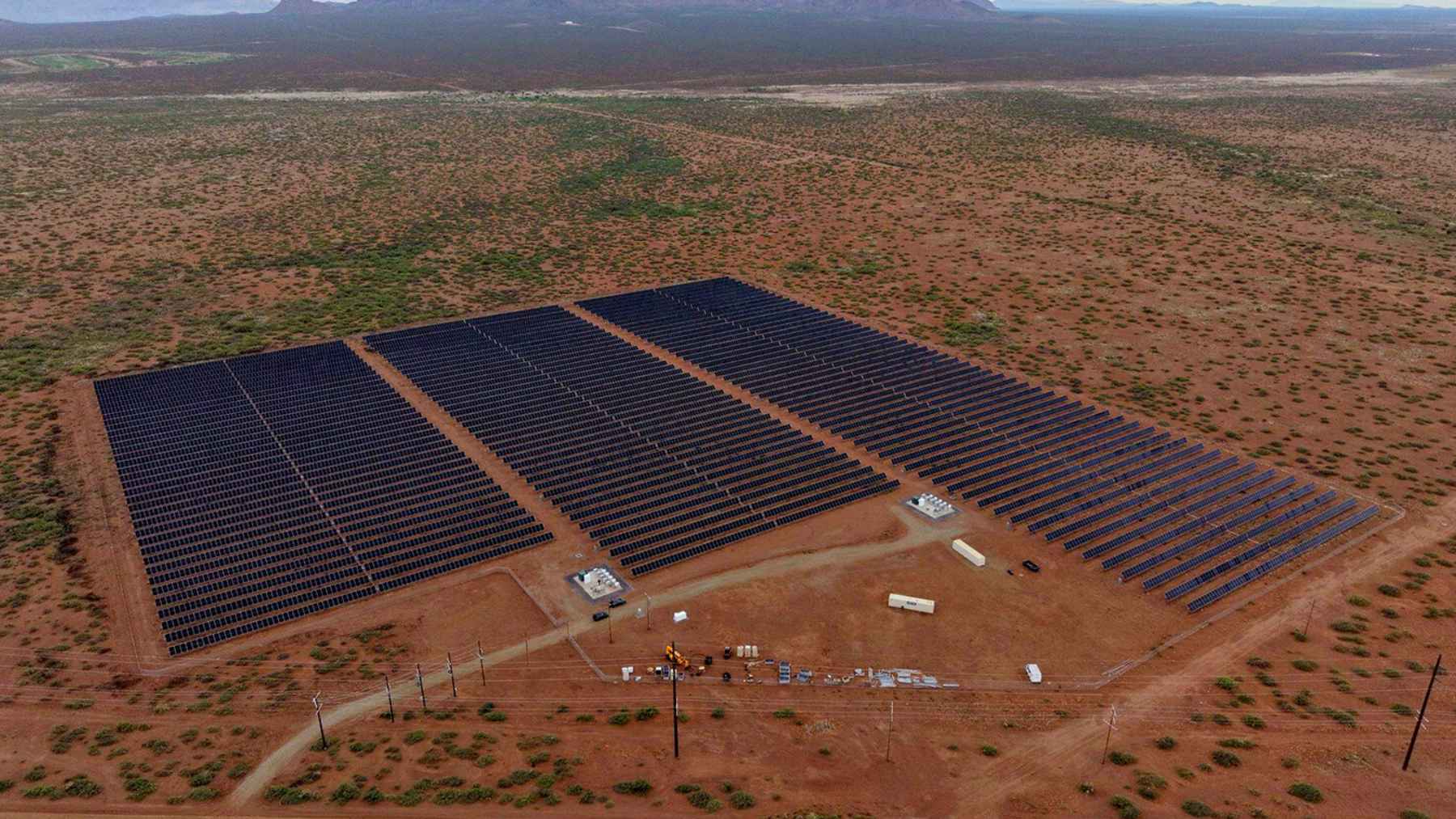 Rows of solar panels installed across a rural landscape in Plasencia, Spain, representing the Las Cruces I project.