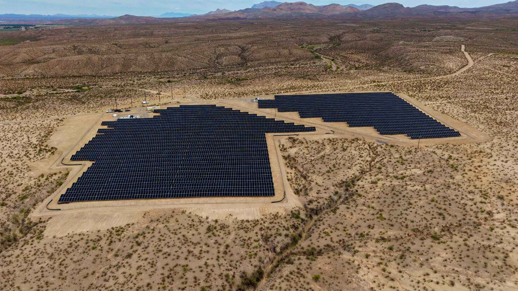 Rows of solar panels installed across a rural landscape in Plasencia, Spain, representing the Las Cruces I project.
