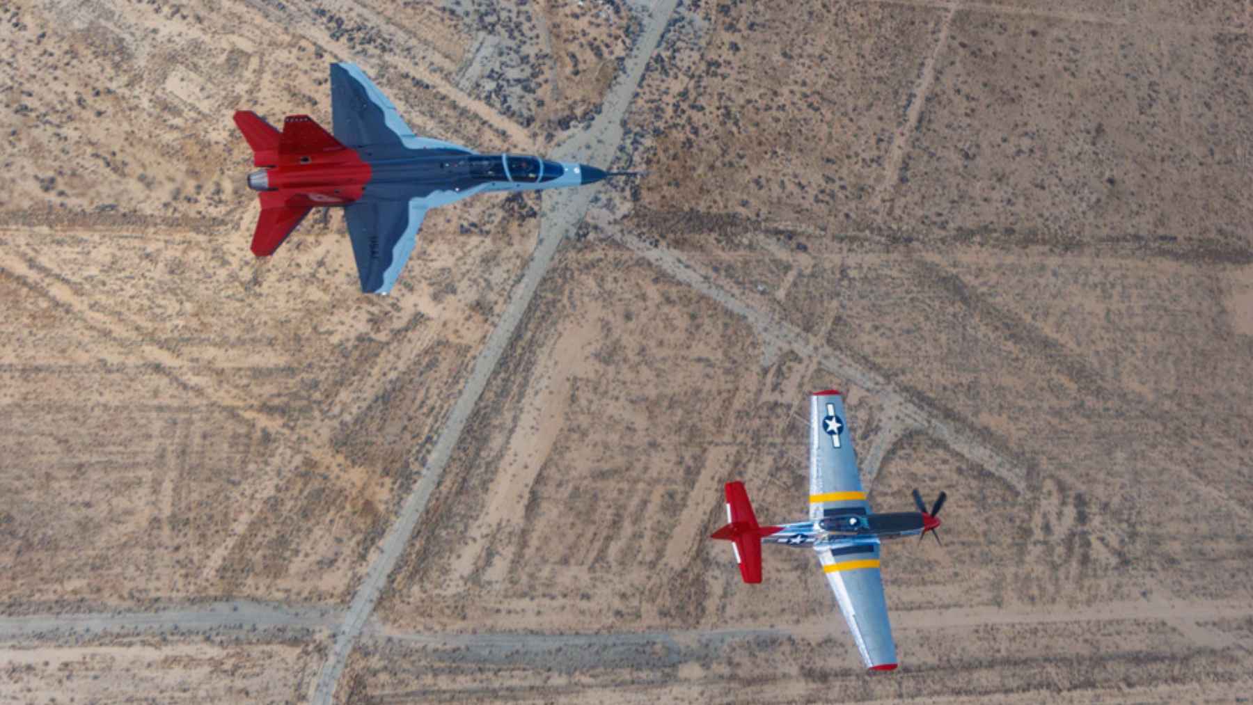 A Boeing T-7A Red Hawk advanced jet trainer aircraft in flight, representing modern military pilot training systems.