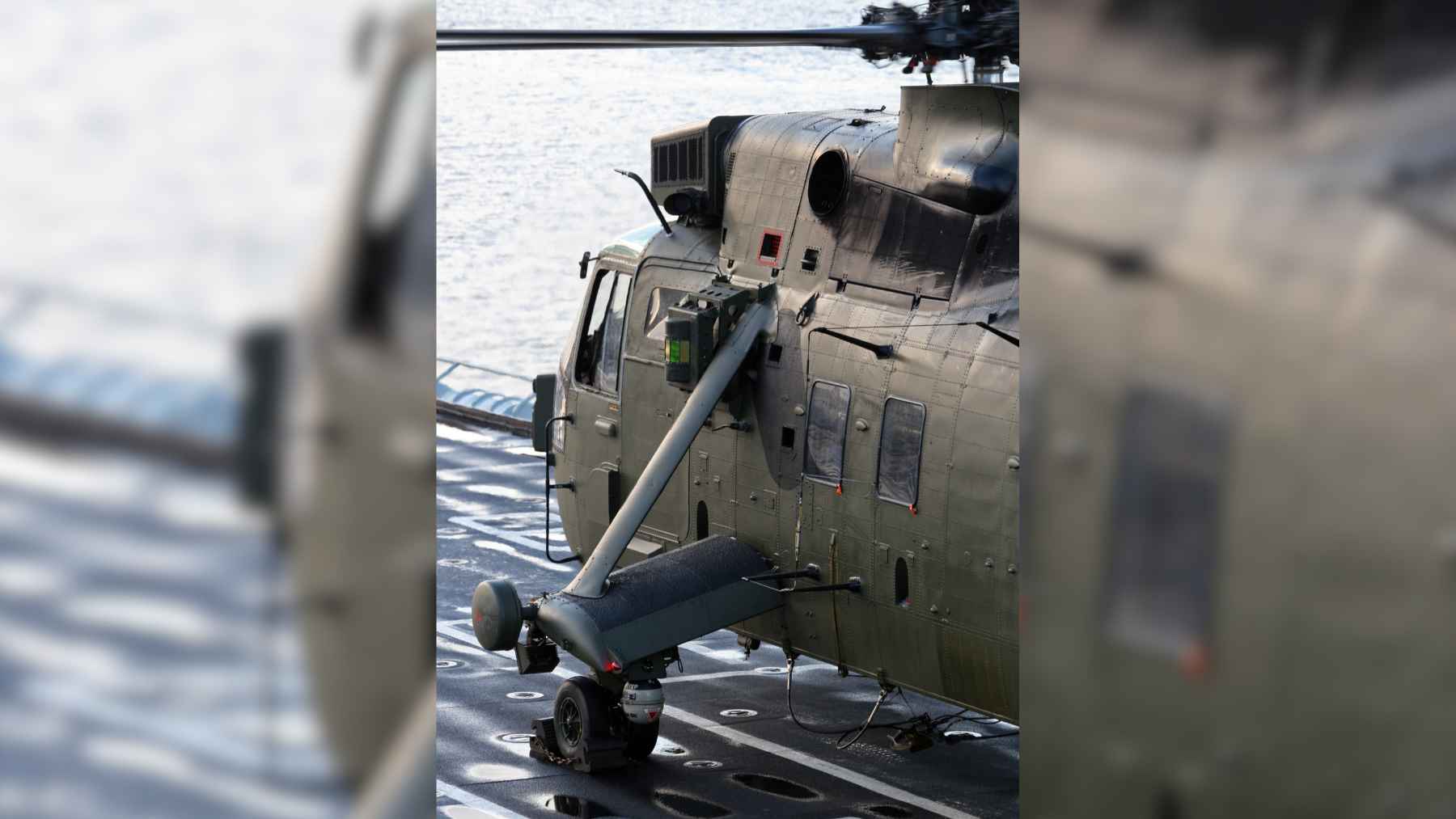 Sea King helicopters handed to Ukraine years ago now sit beside interceptor drones, and the job they ended up doing was never planned 1 A Sea King helicopter equipped with rows of interceptor drones on launch rails at an airshow exhibition.