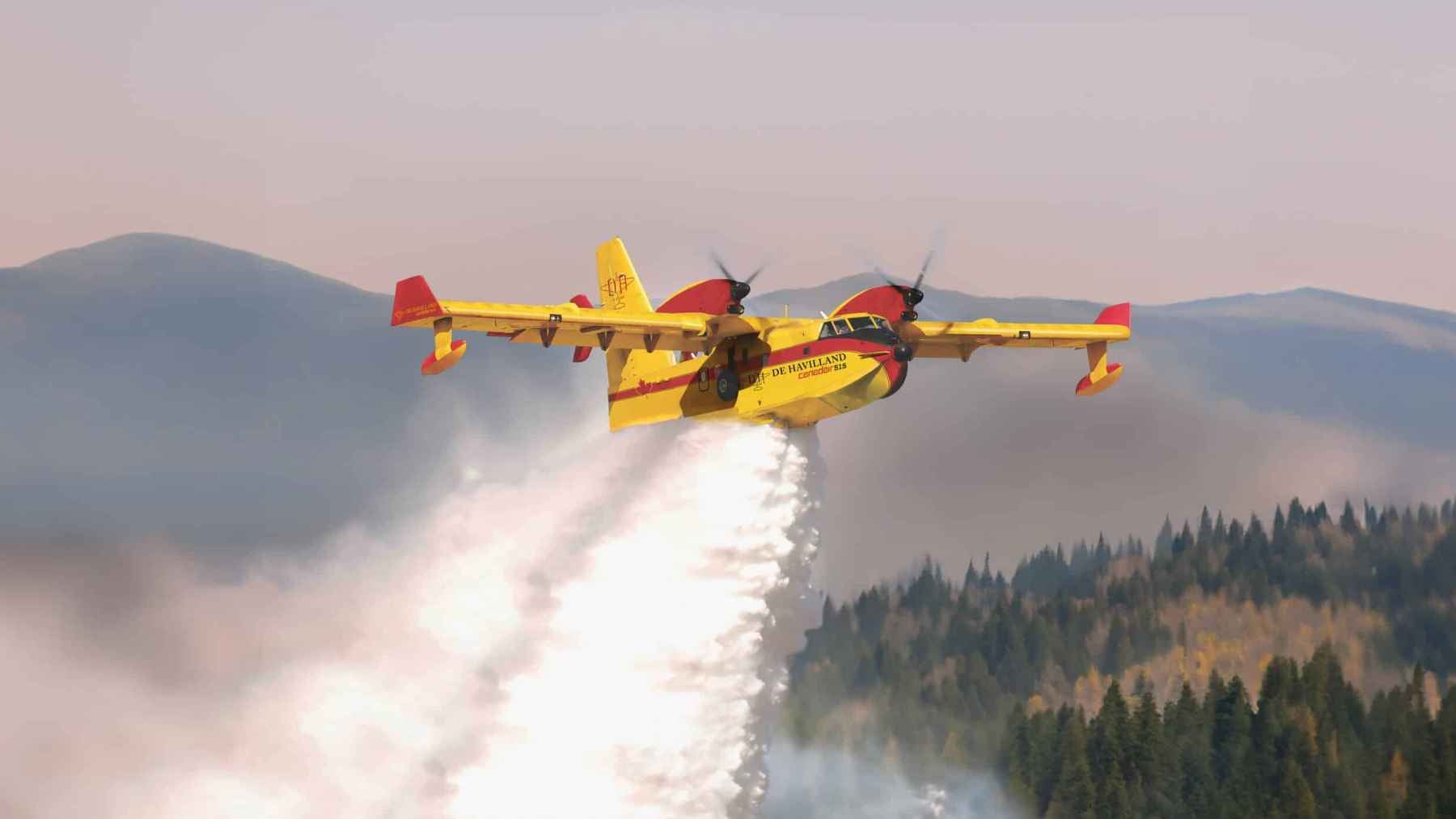 A De Havilland DHC-515 water-bomber firefighting aircraft operating over a water source during aerial suppression.
