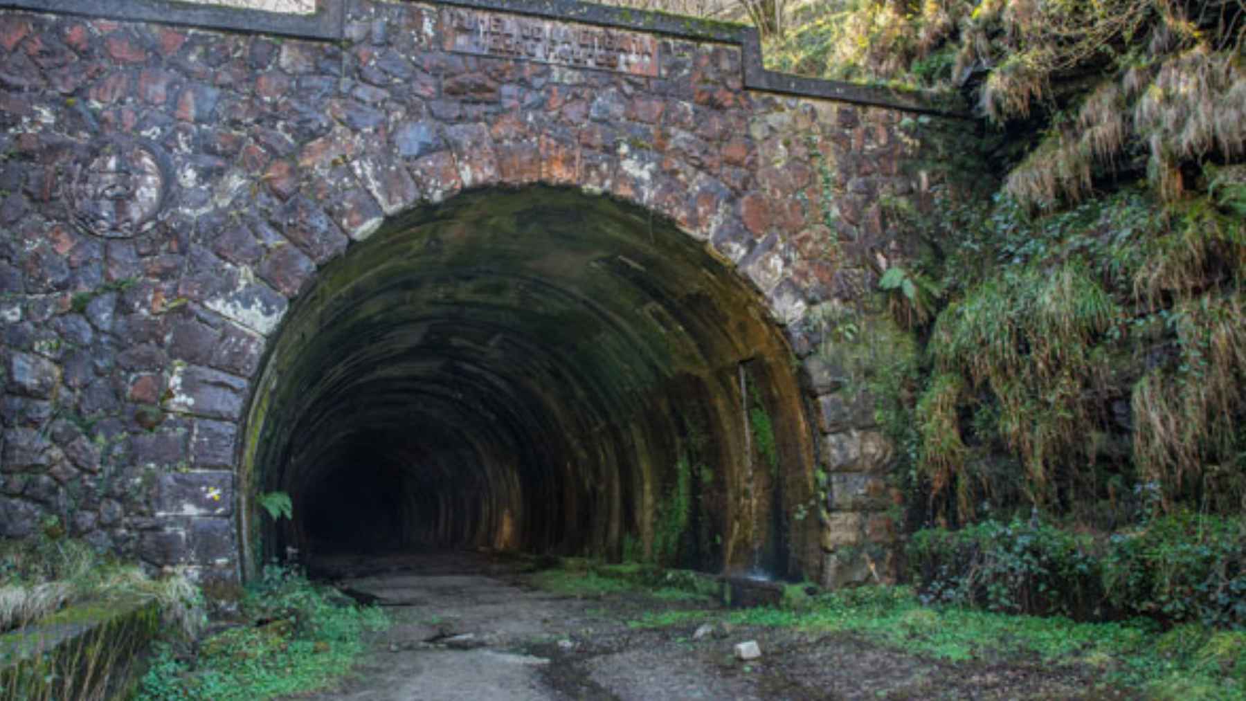 Spain reopened the abandoned La Engaña rail tunnel as a 2.61 mile tourist road that cost 5.49 million dollars, 45% over budget 1 The reopened entrance of the historic La Engaña rail tunnel in Cantabria, Spain, featuring new road access and tourism infrastructure.