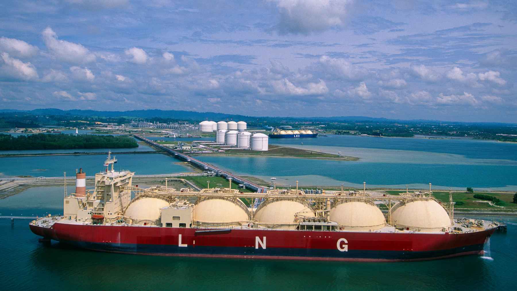 Banning Russian gas won't free Europe: a top Spanish import hub warns it just hands power to the US 1 LNG carrier ship docked at an industrial port terminal, representing liquefied natural gas trade and energy supply security.