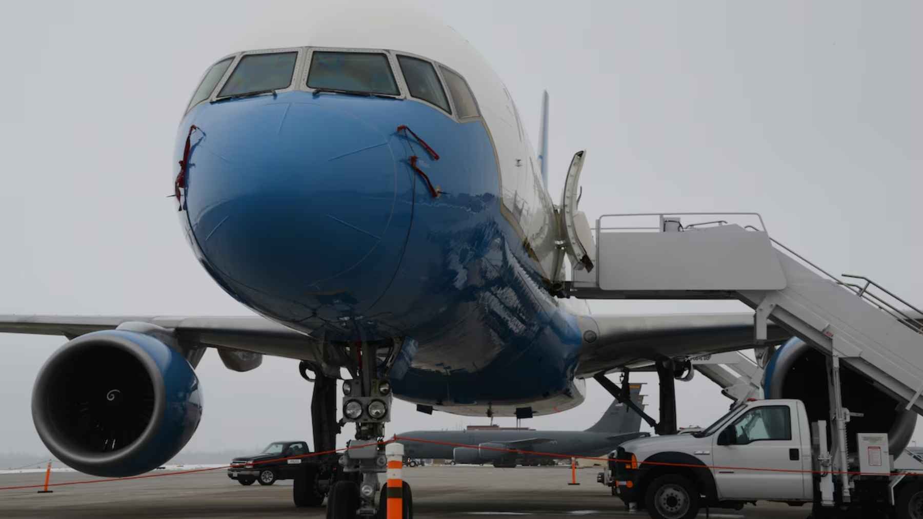 A US government Boeing C-32A parked at an airport, showcasing the new executive airlift paint scheme.